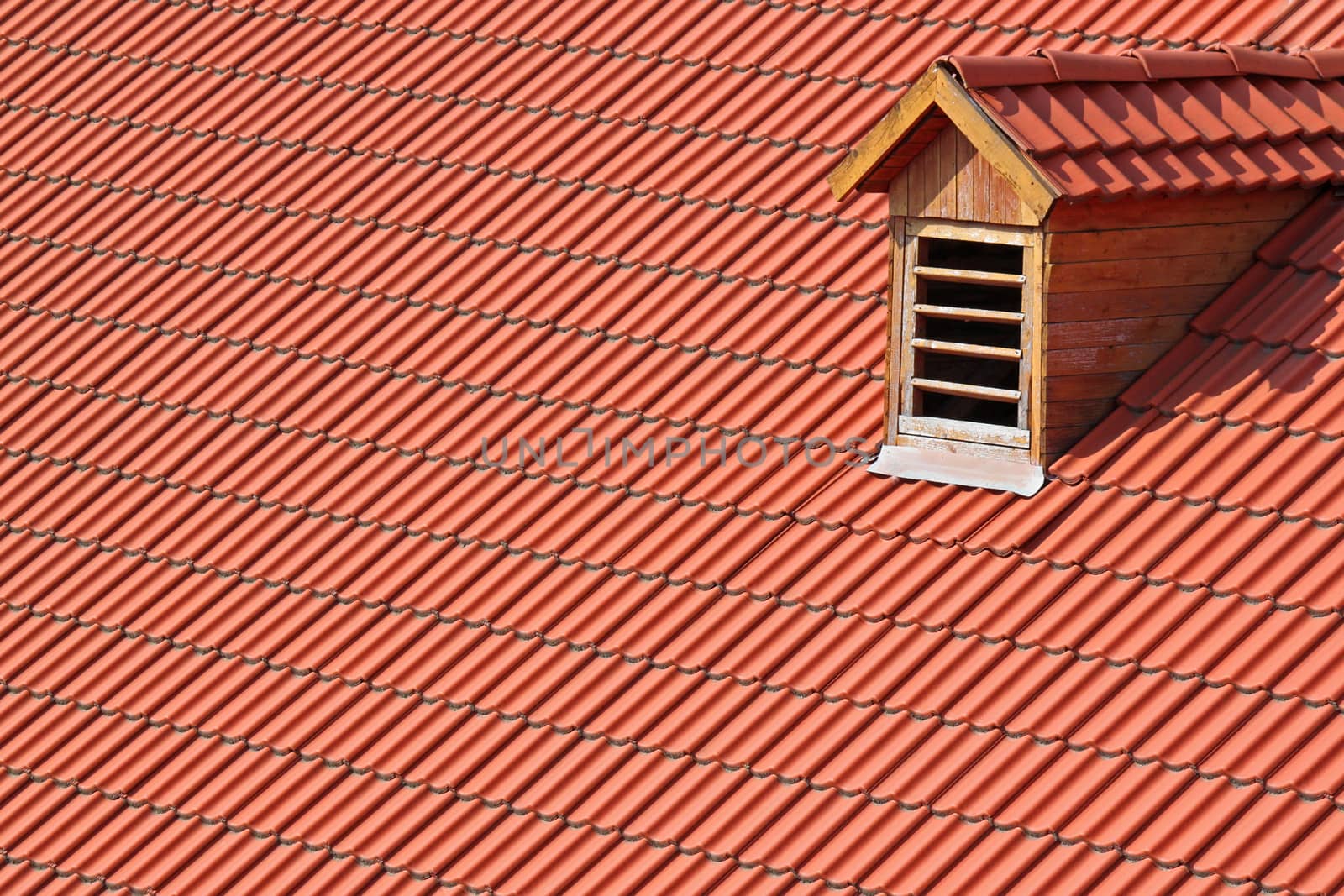 garret window on red tiled roof