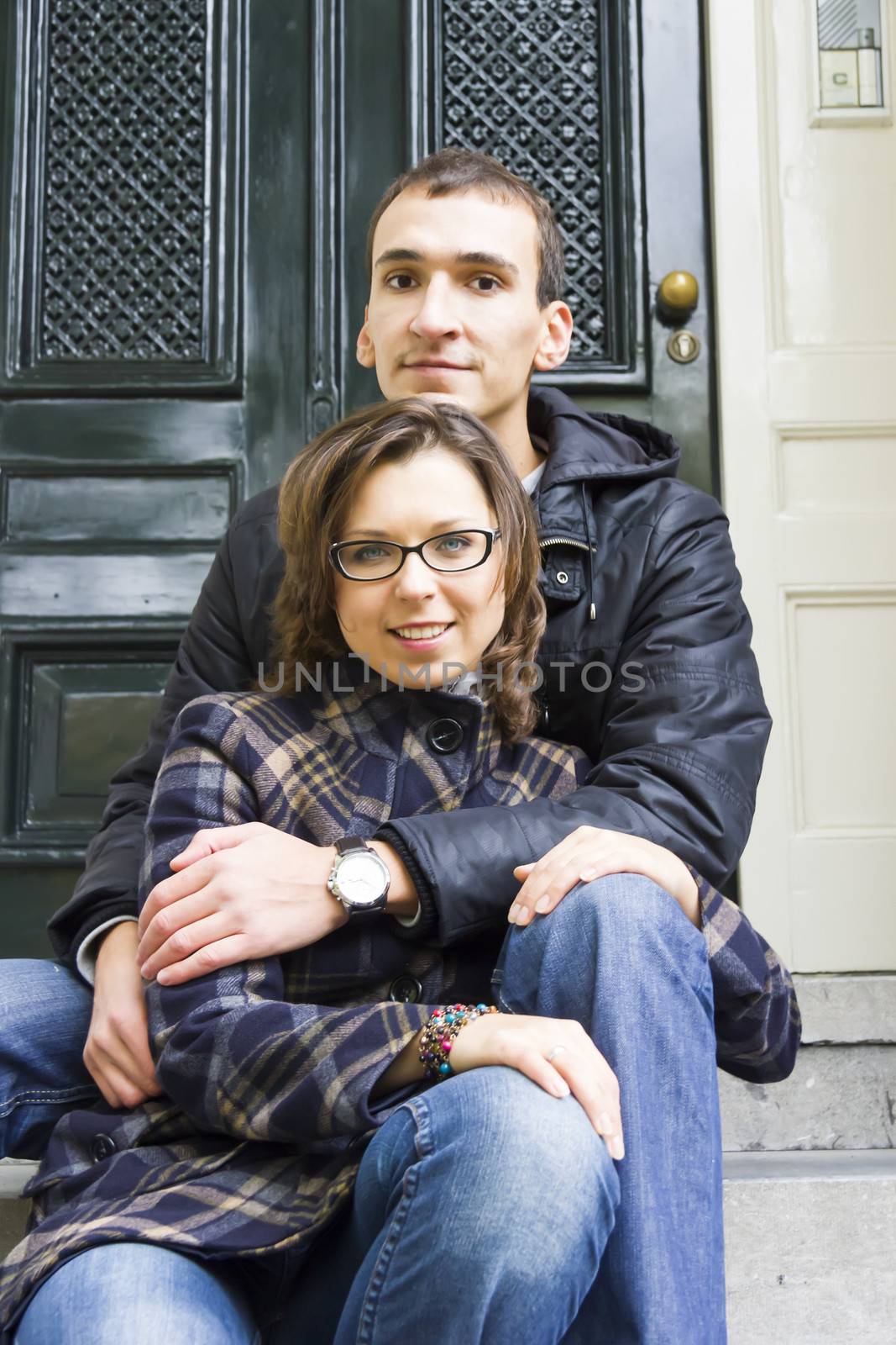 Portrait of love couple sitting on traditional Dutch porch looki by Tetyana