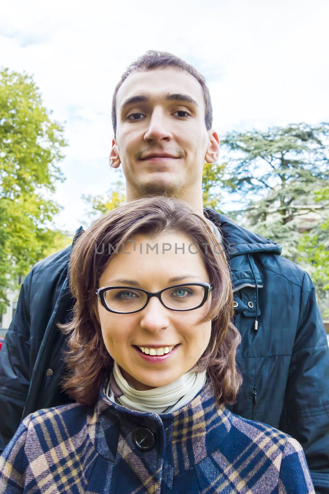 Portrait of love couple  outdoor looking happy by Tetyana