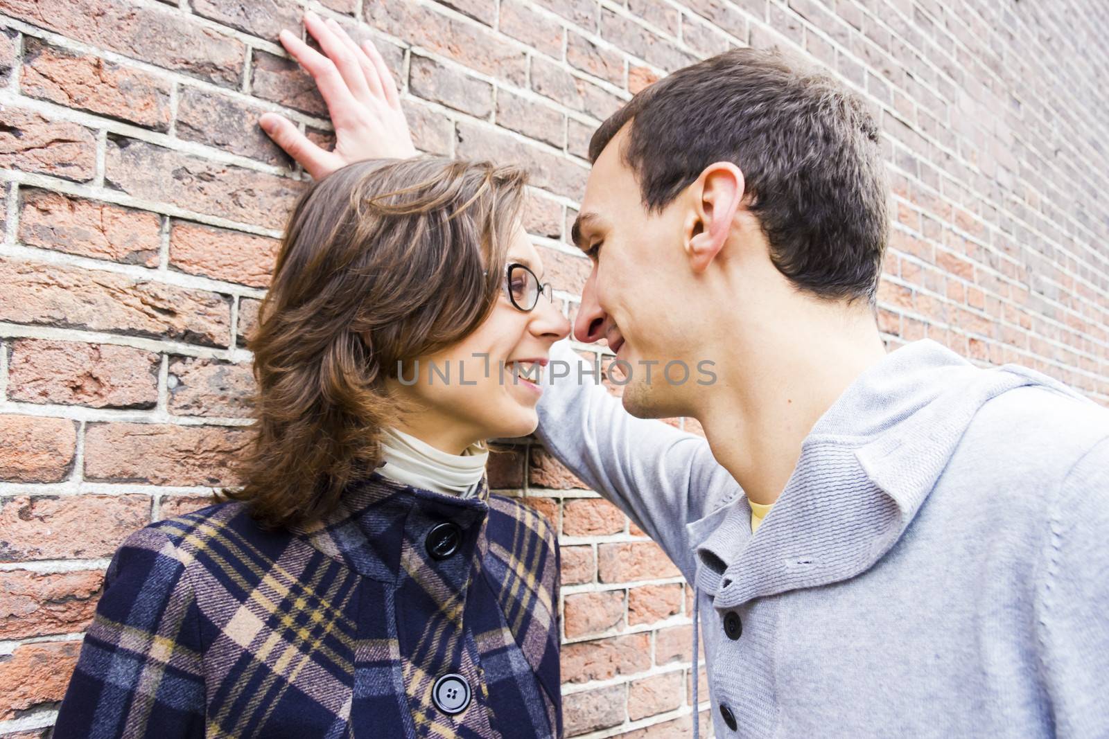 Portrait of love couple looking happy against wall background