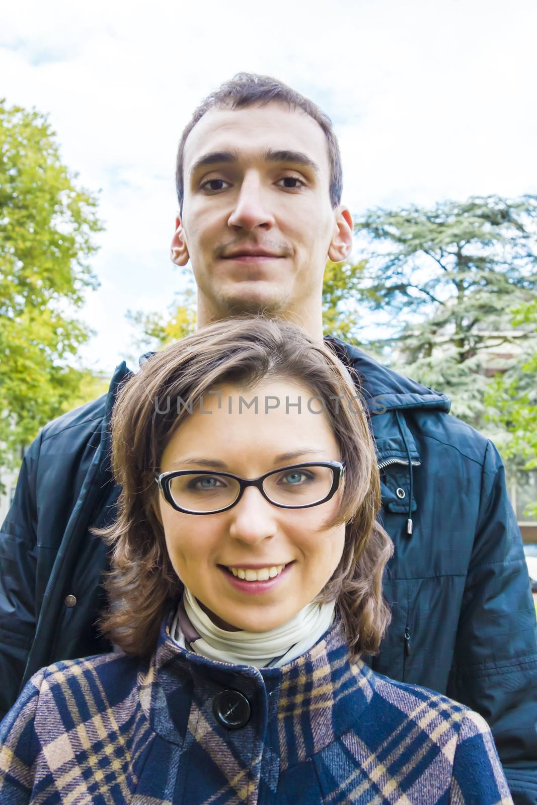 Portrait of love couple  outdoor looking happy by Tetyana