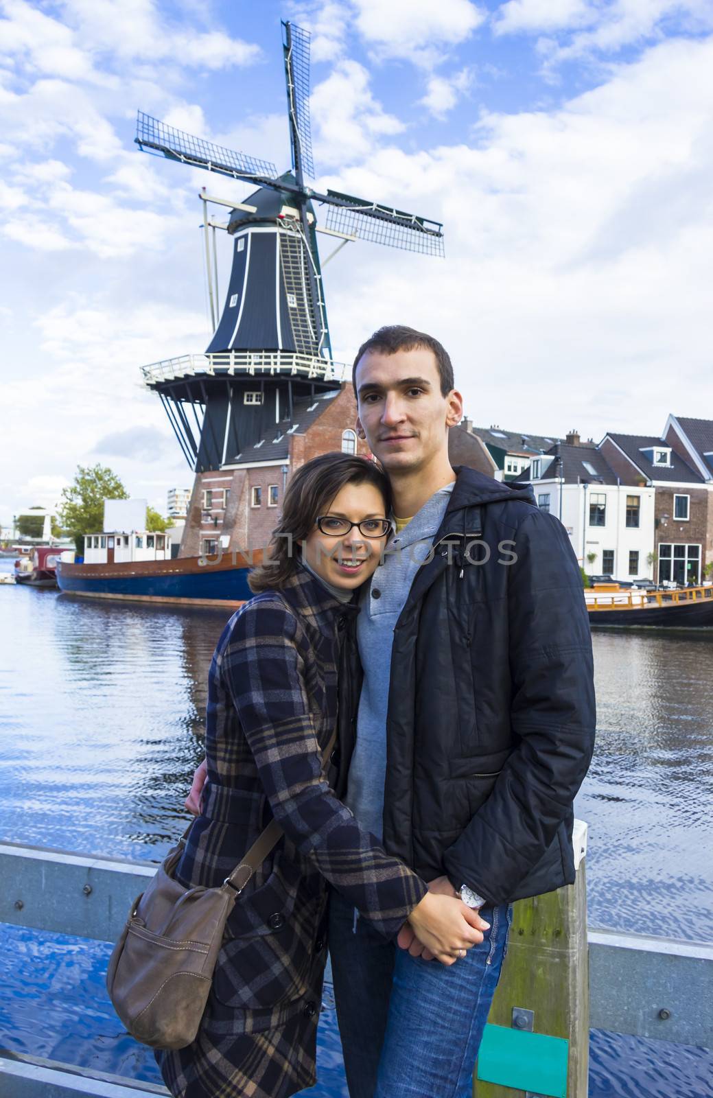 Portrait of love couple embracing outdoor in park looking happy