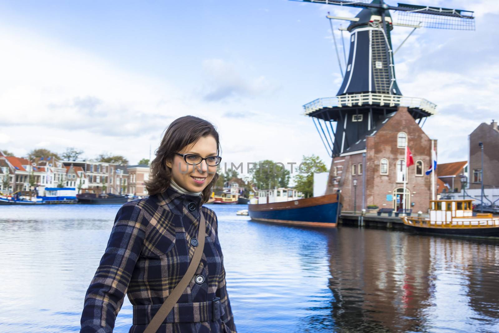 Girl on waterfront in Dutch town of Haarlem, the Netherlands