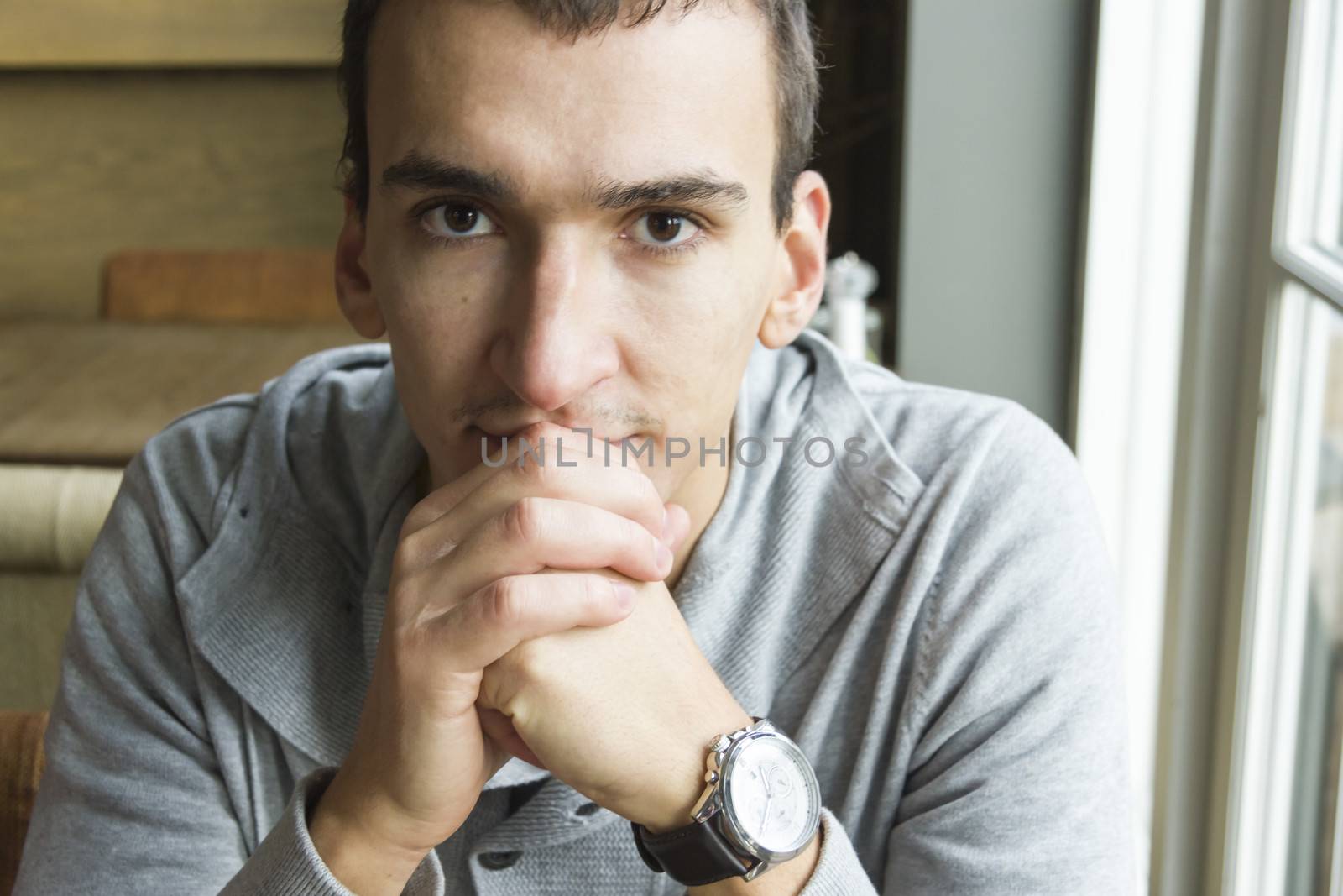 Portrait of handsome man, close up of young businessman indoors by Tetyana