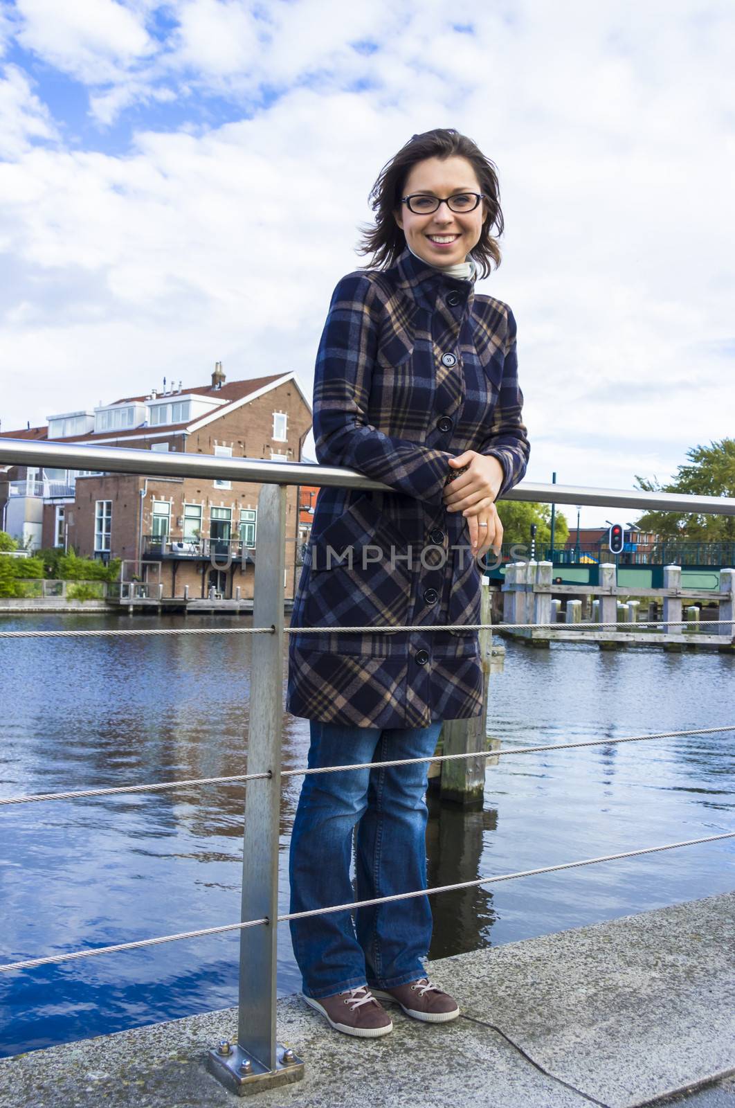 Girl on waterfront in Dutch town of Haarlem, the Netherlands by Tetyana