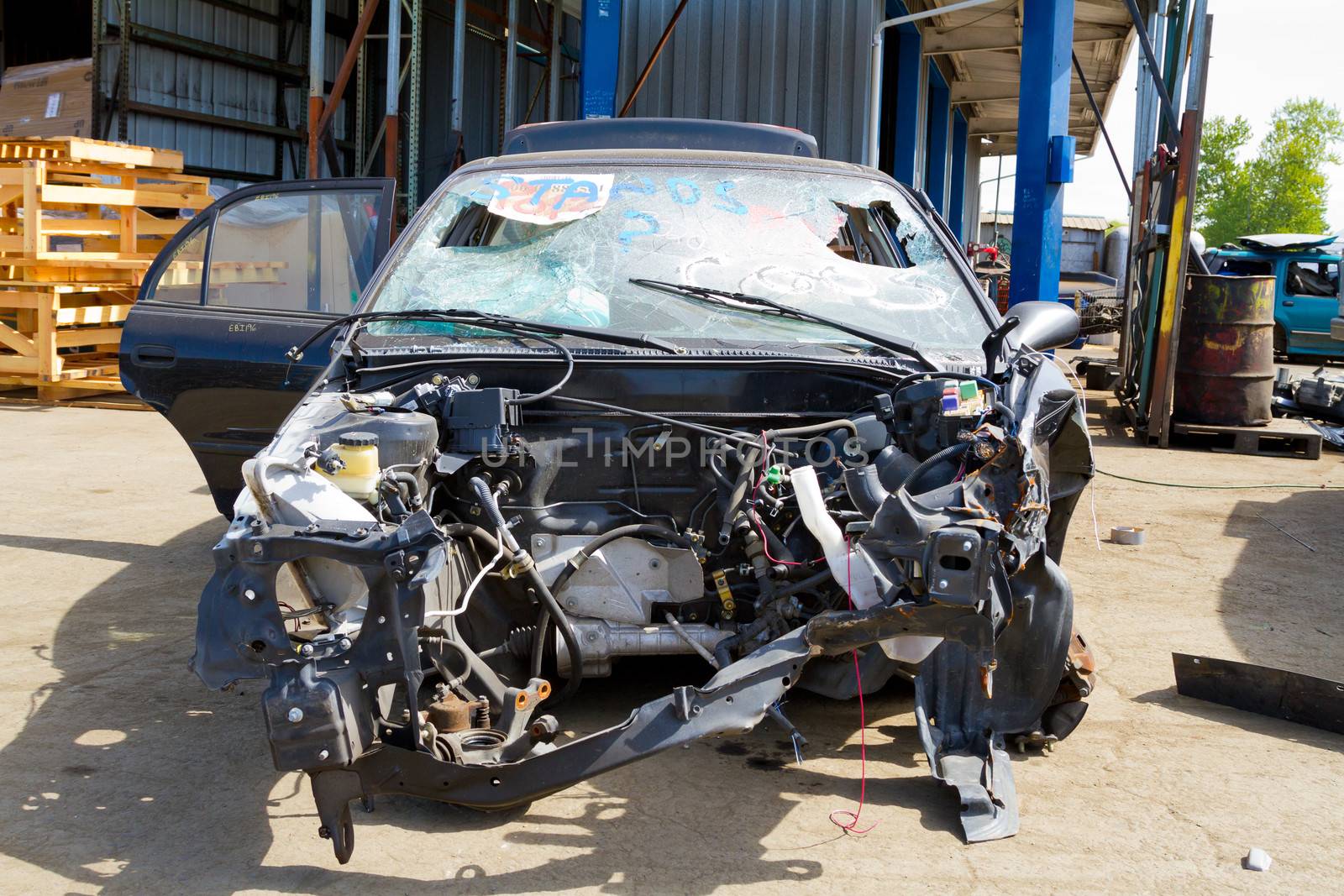 Detail of a vehicle at the auto salvage yard after a major accident collision.