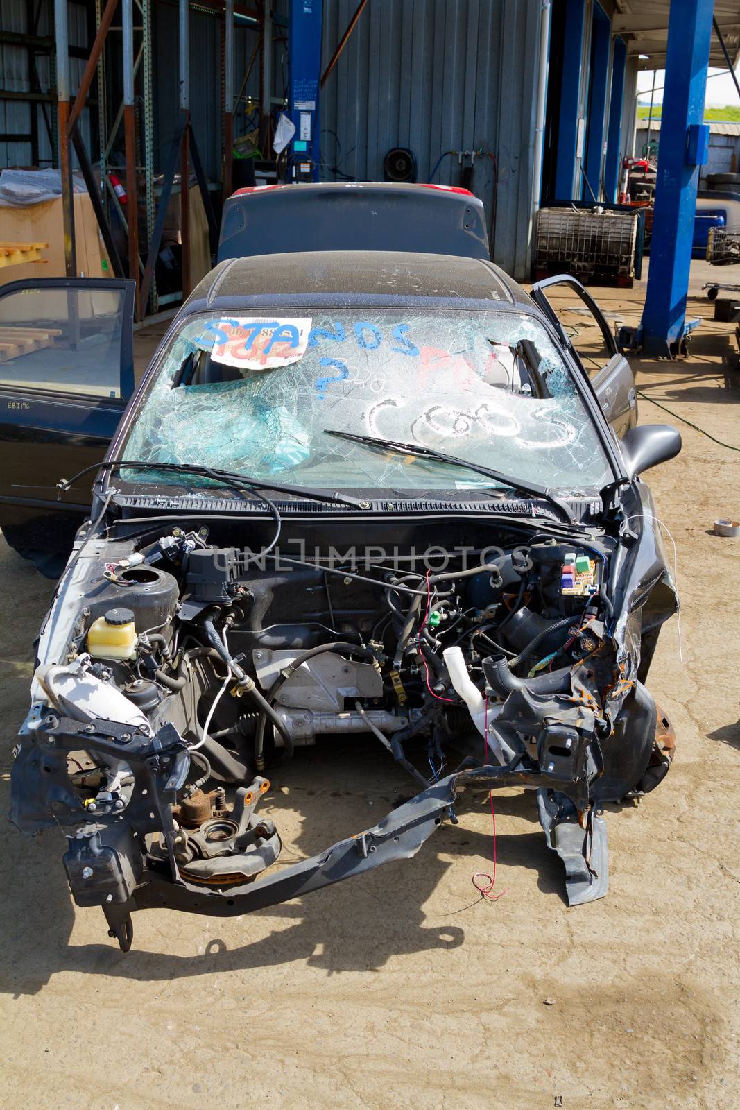 Detail of a vehicle at the auto salvage yard after a major accident collision.