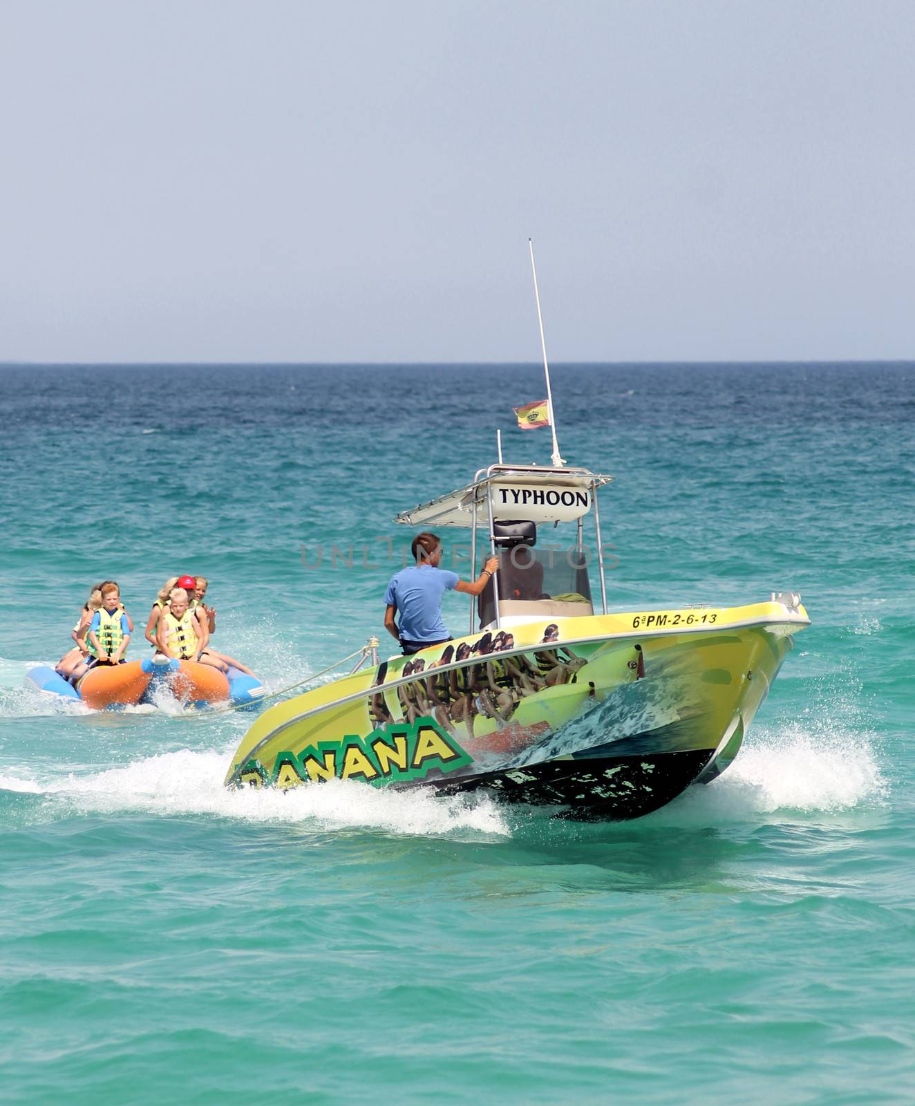 ALCUDIA , MAJORCA, SPAIN - 8th August 2013: Children enjoying a banana boat ride in Alcudia on the 8th August 2013. 