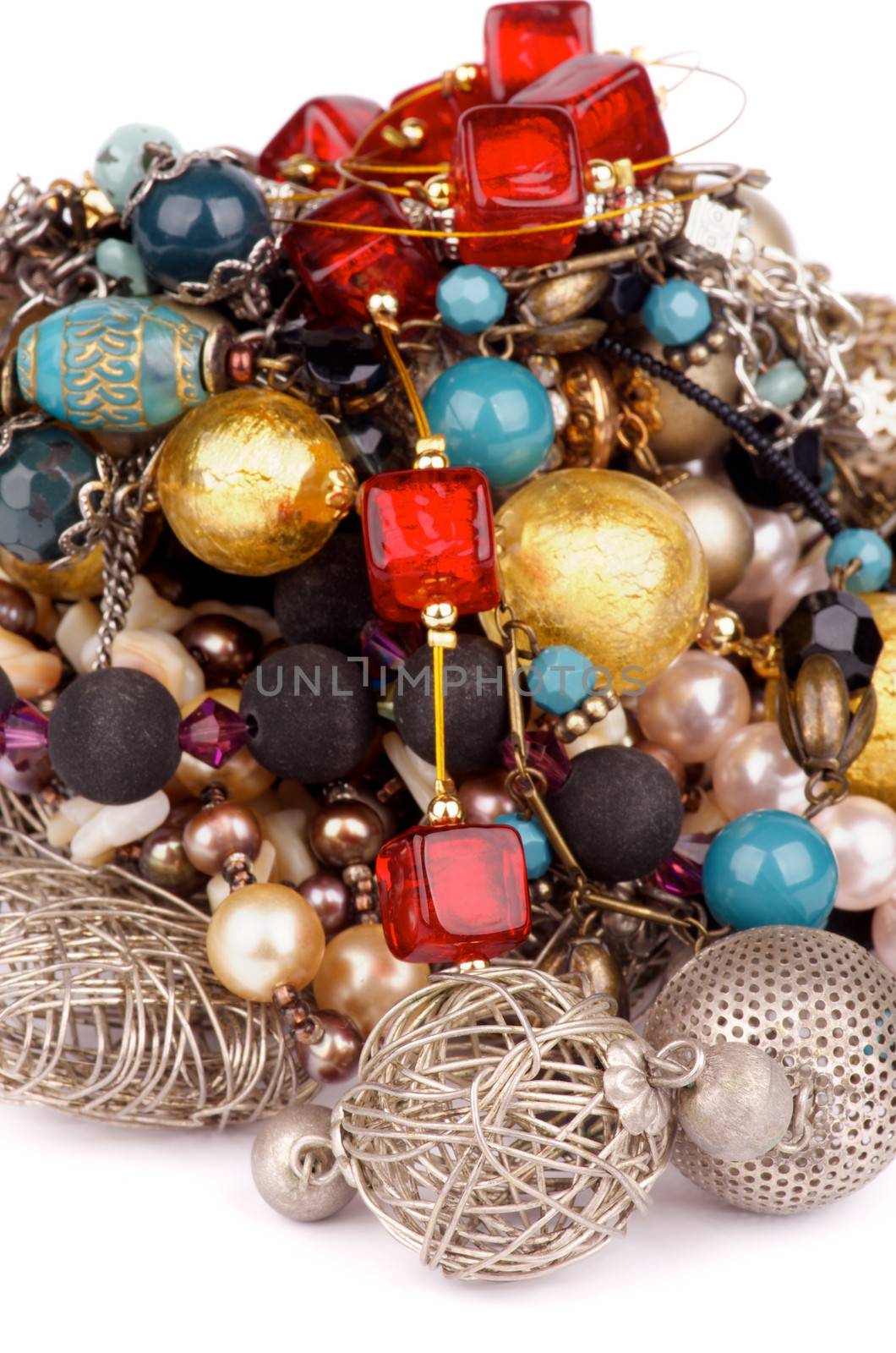 Heap of Jewelry with Gold Bracelets, Ruby Necklace, Pearl and Gem Beads isolated on white background