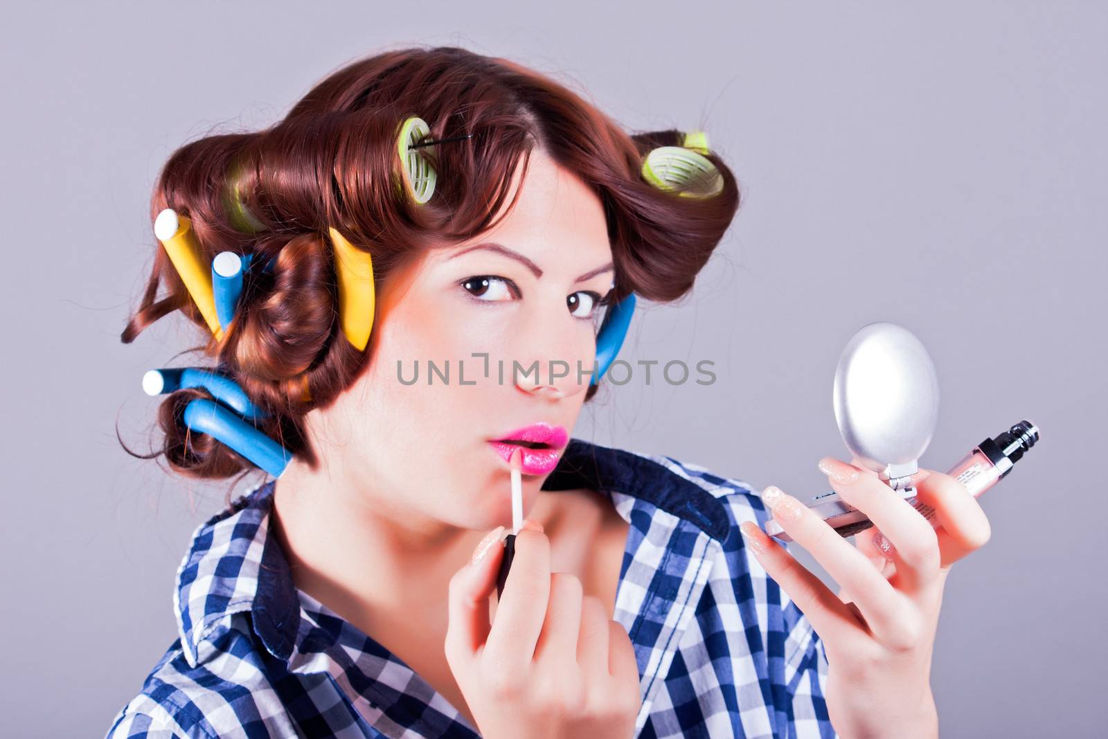 Attractive girl applying mascara by dukibu