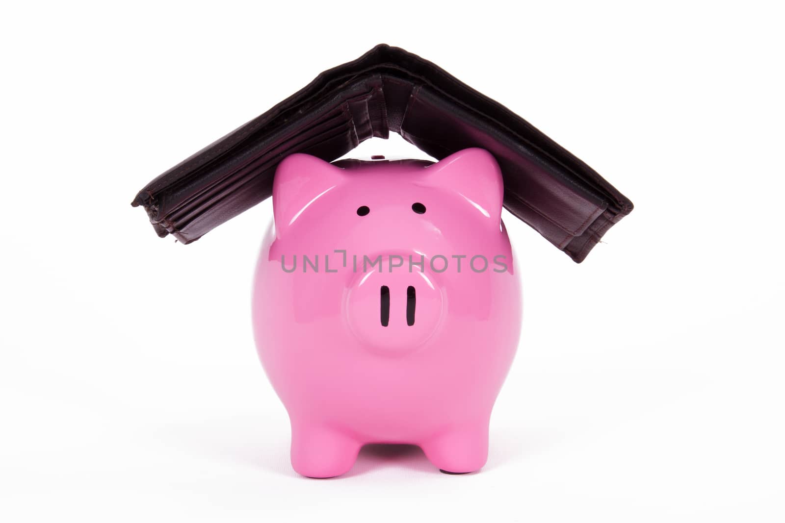 Pink piggy bank protected by dark wallet, isolated on white background.