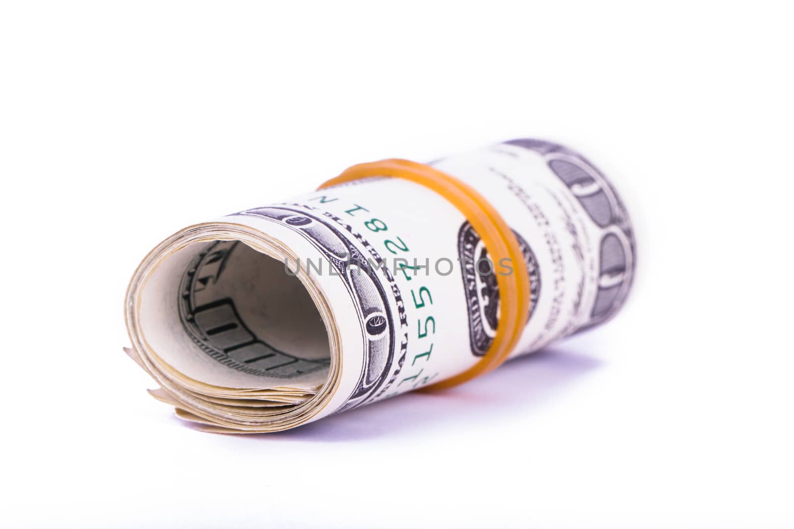 Roll of one hundred dollar banknotes, isolated on white background.