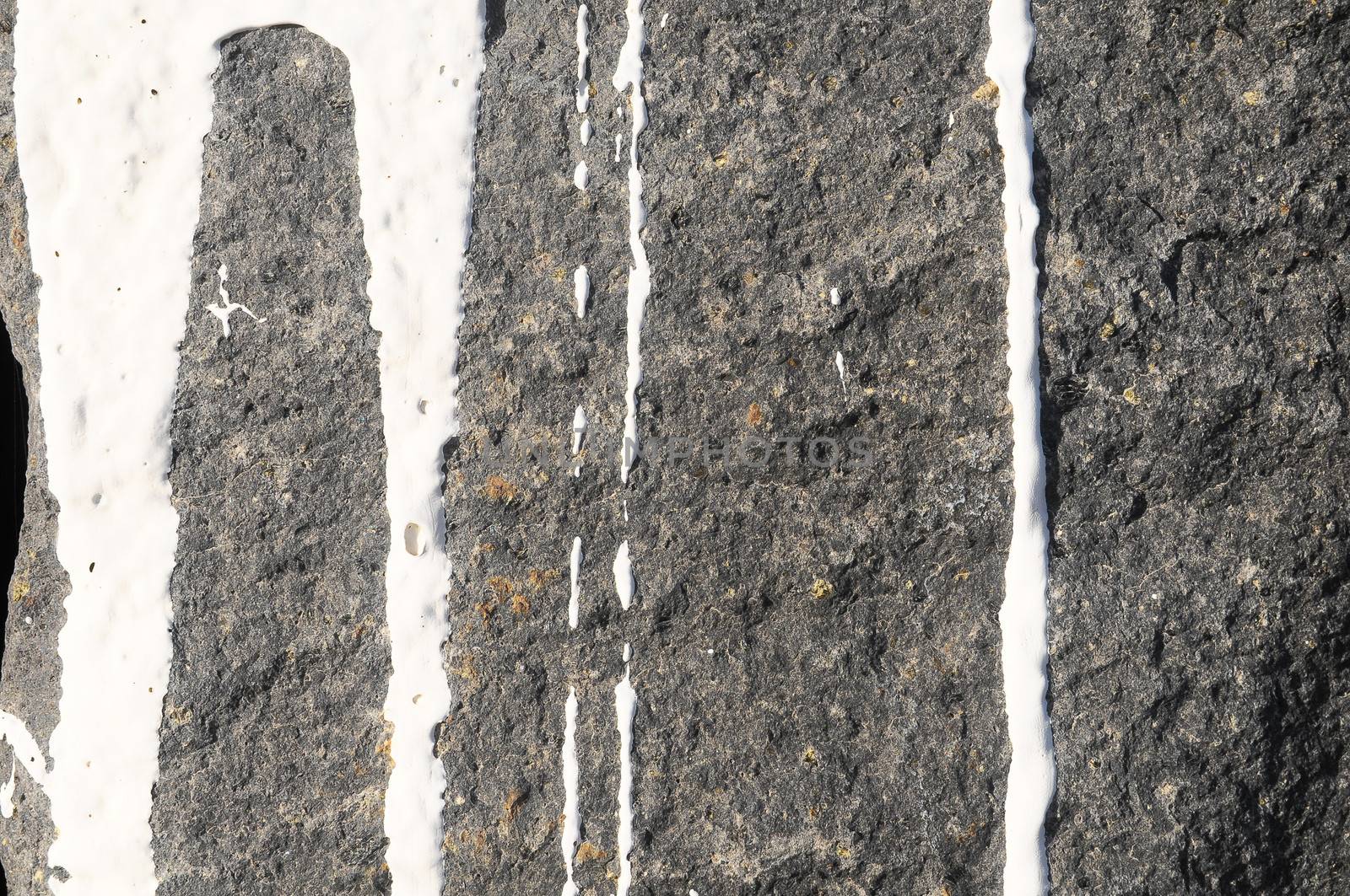 Texture Gray Rock Ancient Wall made of Volcanic Rocks and Dropping Paint