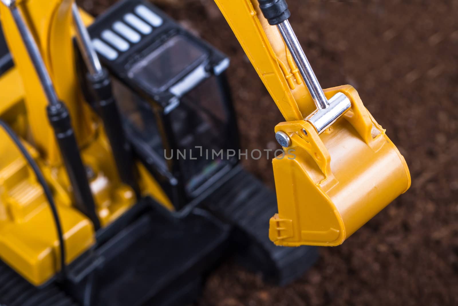 Construction machine, detail view of excavator on pile of soil.