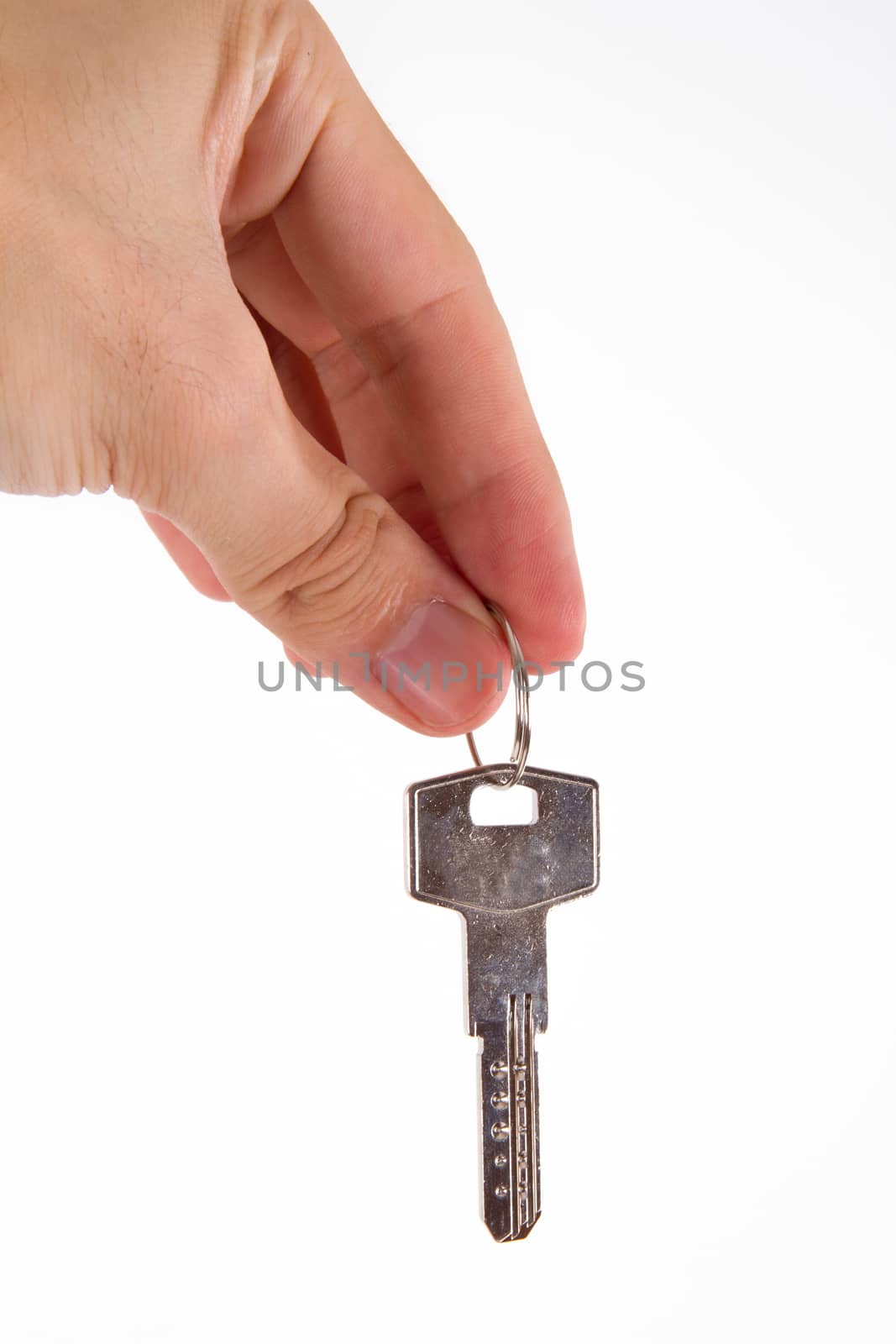 Human hand giving, reaching door key to someone, isolated on white background.