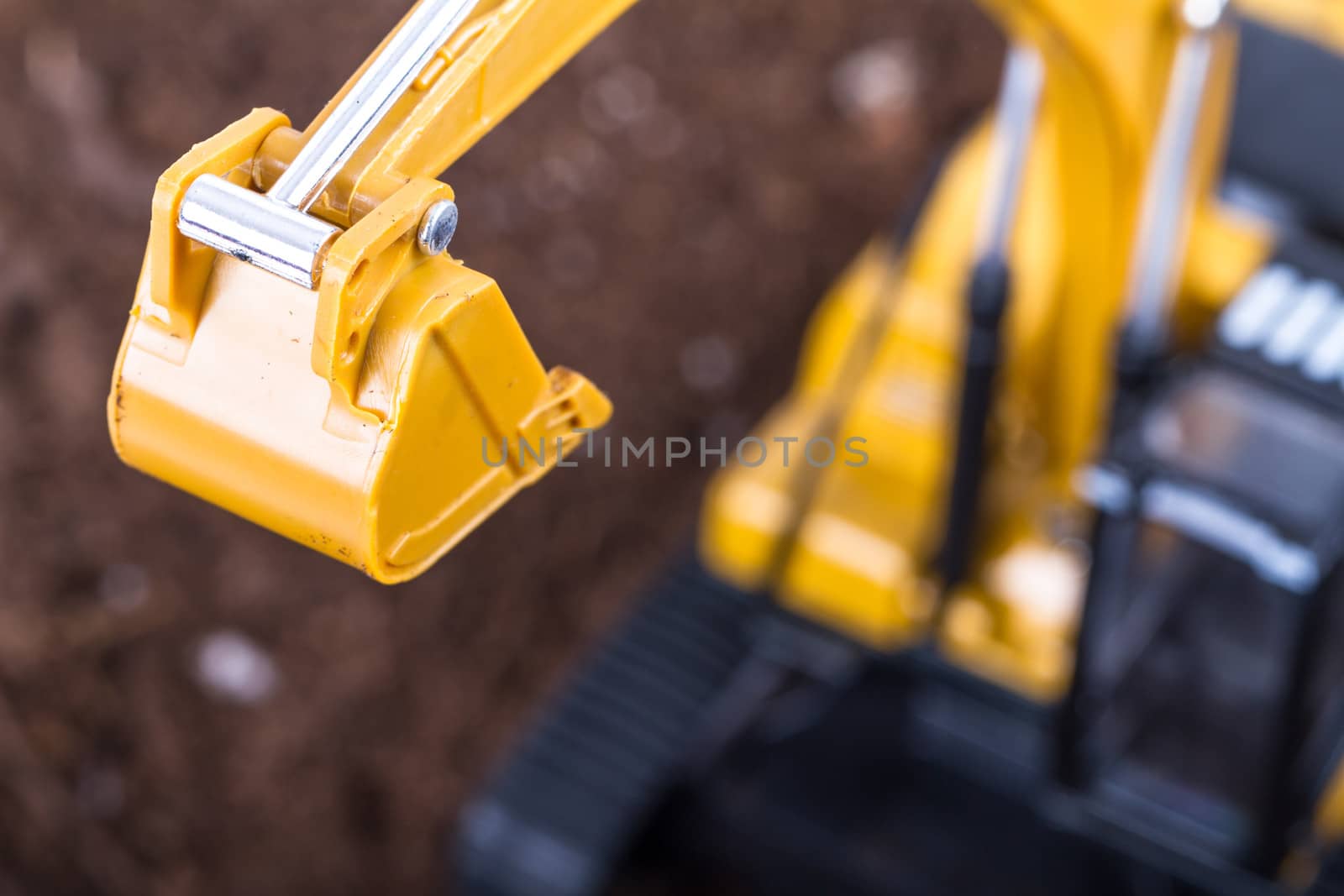 Construction machine, detail view of excavator on pile of soil.