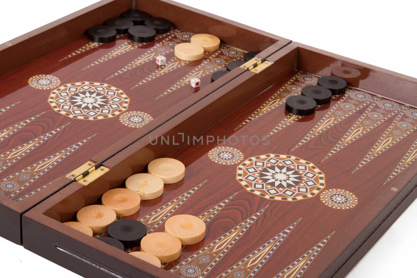 Backgammon table, chips and dices during the game, isolated on white background.