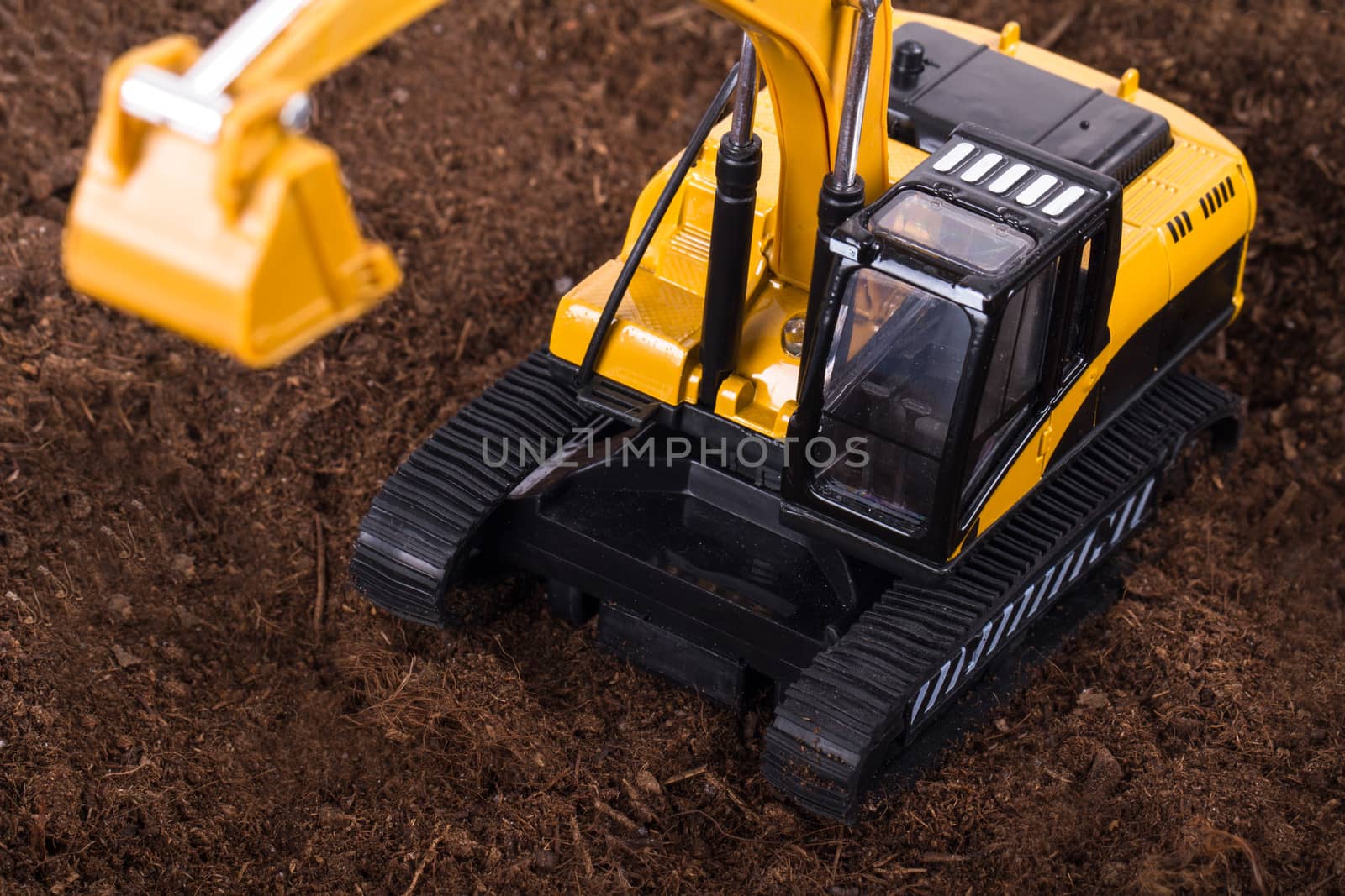 Construction machine, detail view of excavator on pile of soil.