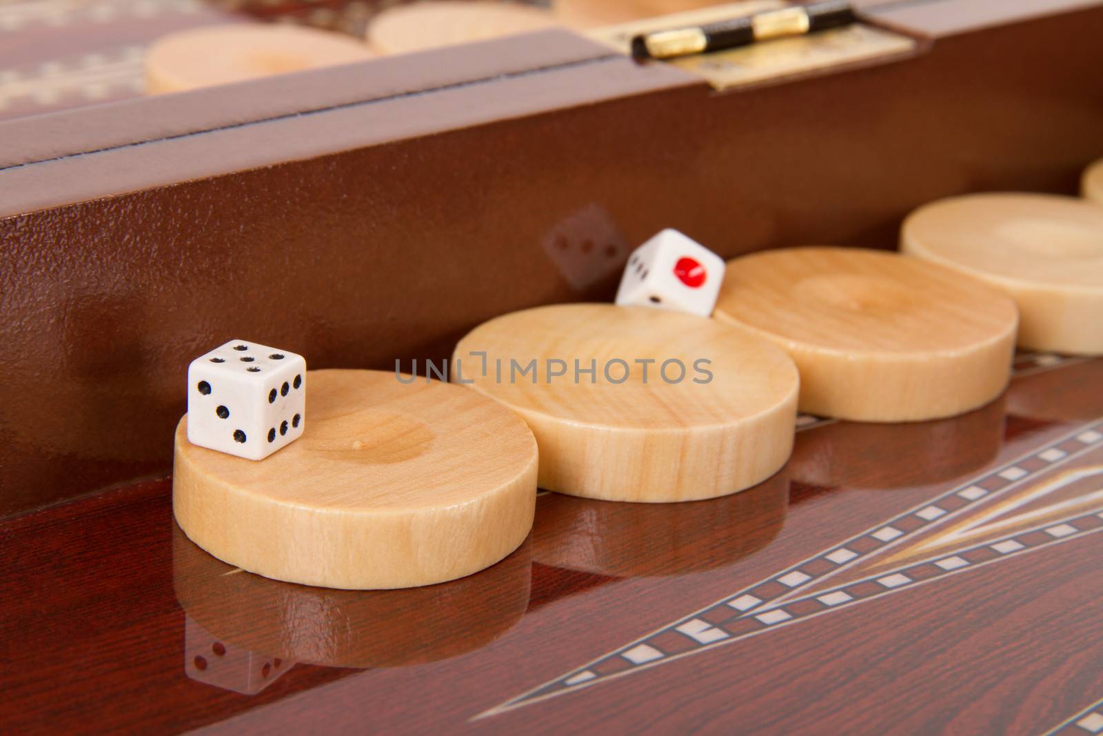 Chips and dices on backgammon table.