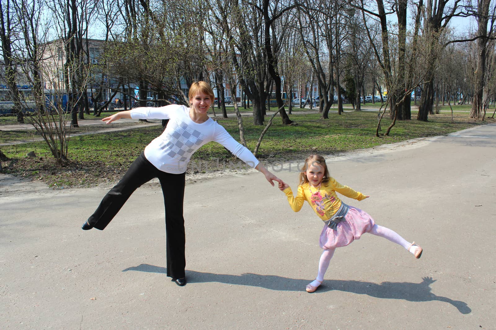 image of mother and the daughter dancing in the city