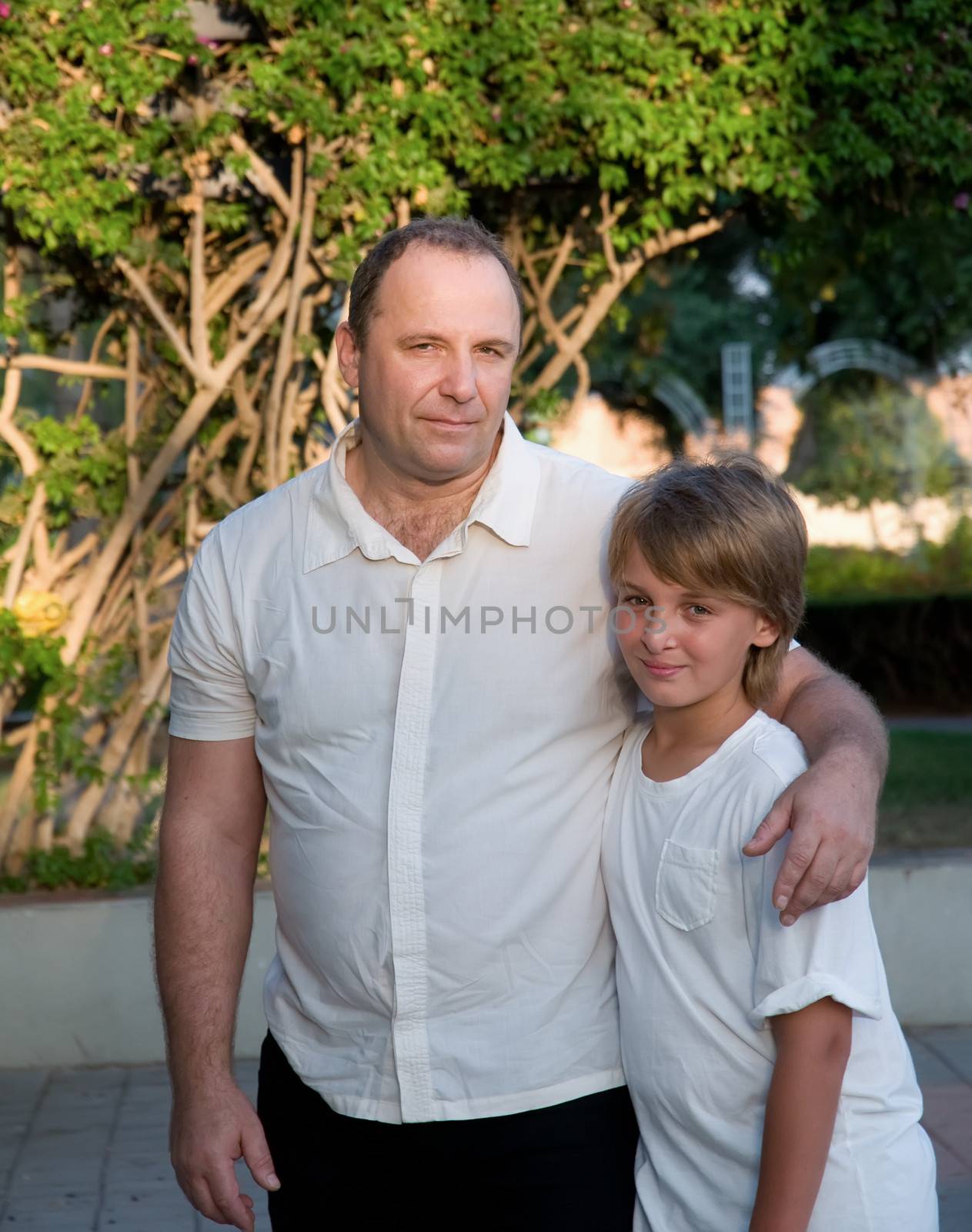 Happy dad with son in a park .