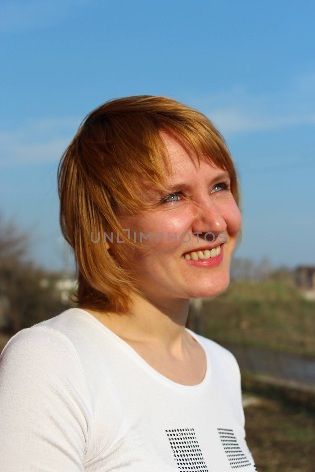 image of blue-eyed sympathetic girl looking at the sky