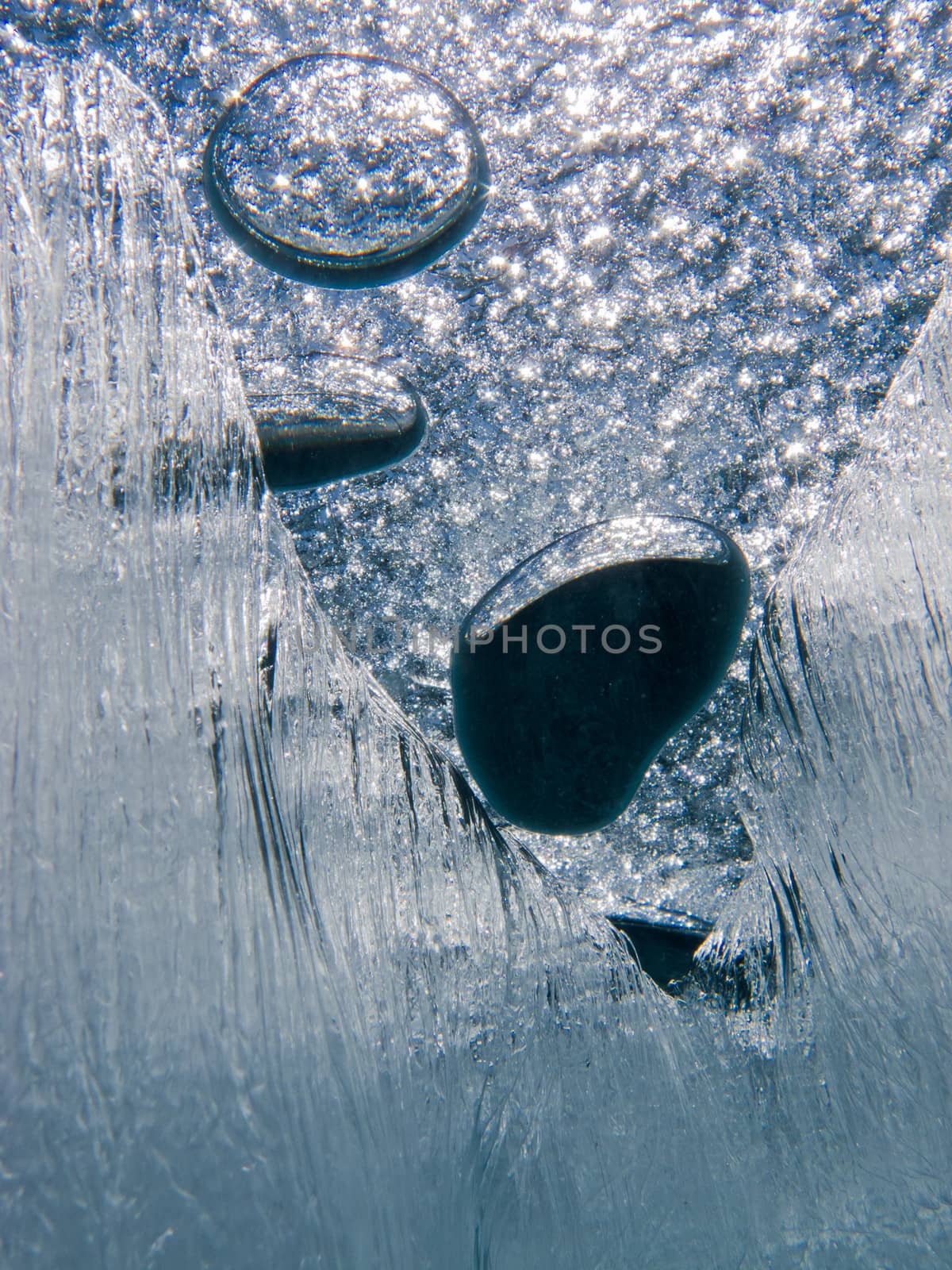 Air bubbles trapped under frozen ice surface mysterious underwater abstract
