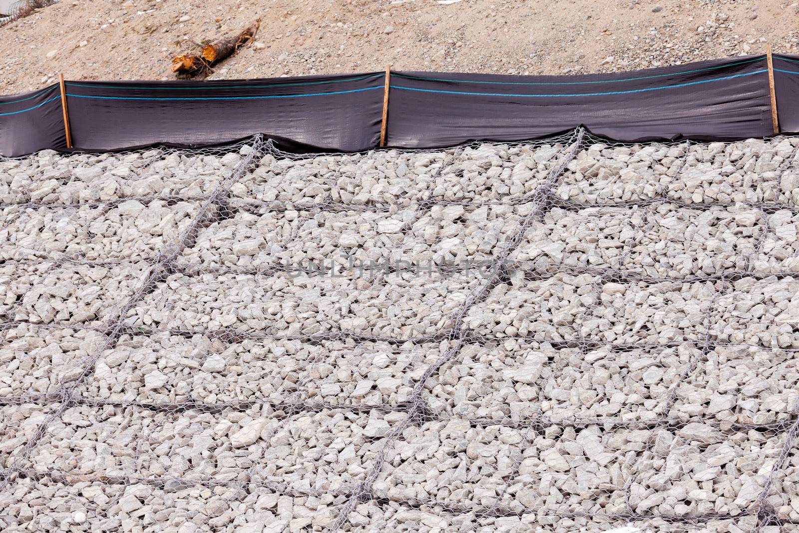 Gravel and wire mesh used in bank revetment to control river bank erosion protection