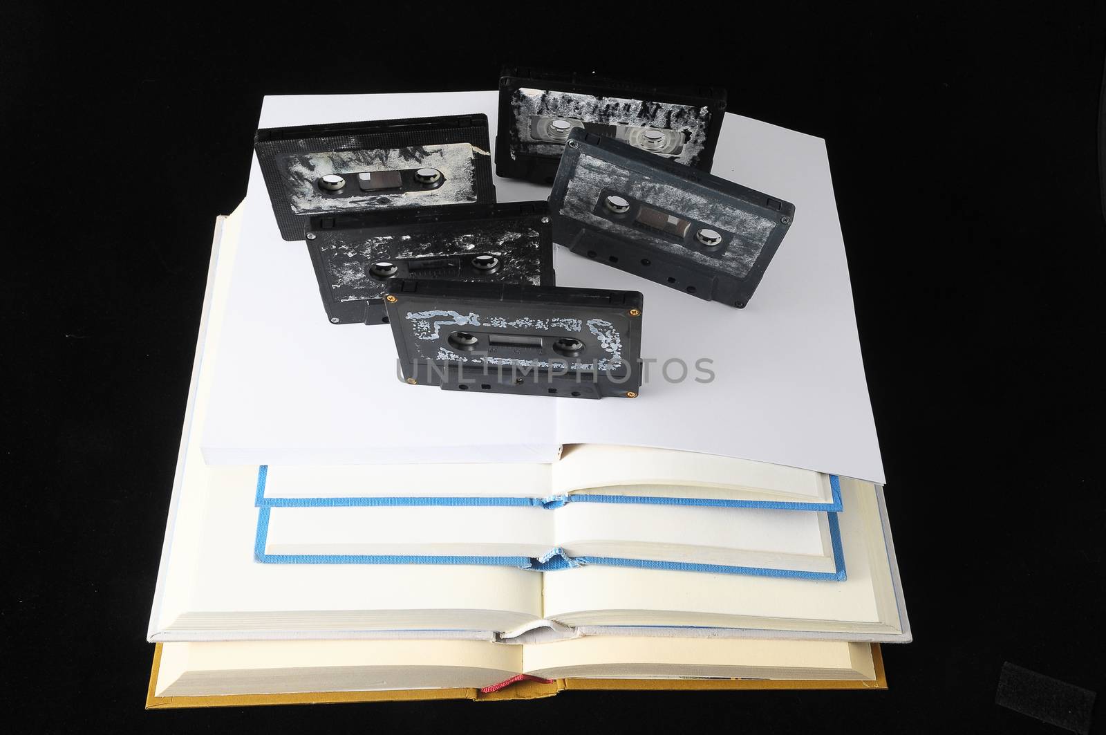 Empty Classic Book and Music Tape Isolated over a Black Background