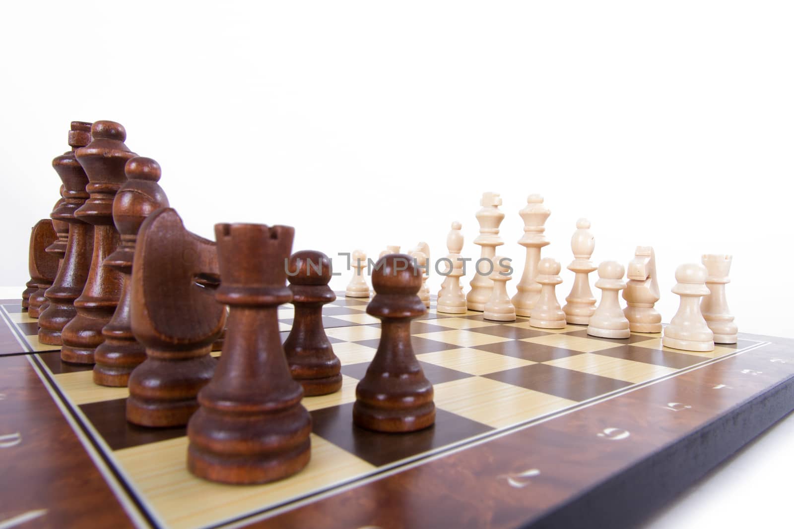 Chess board with chess pieces in a row, isolated on white background.