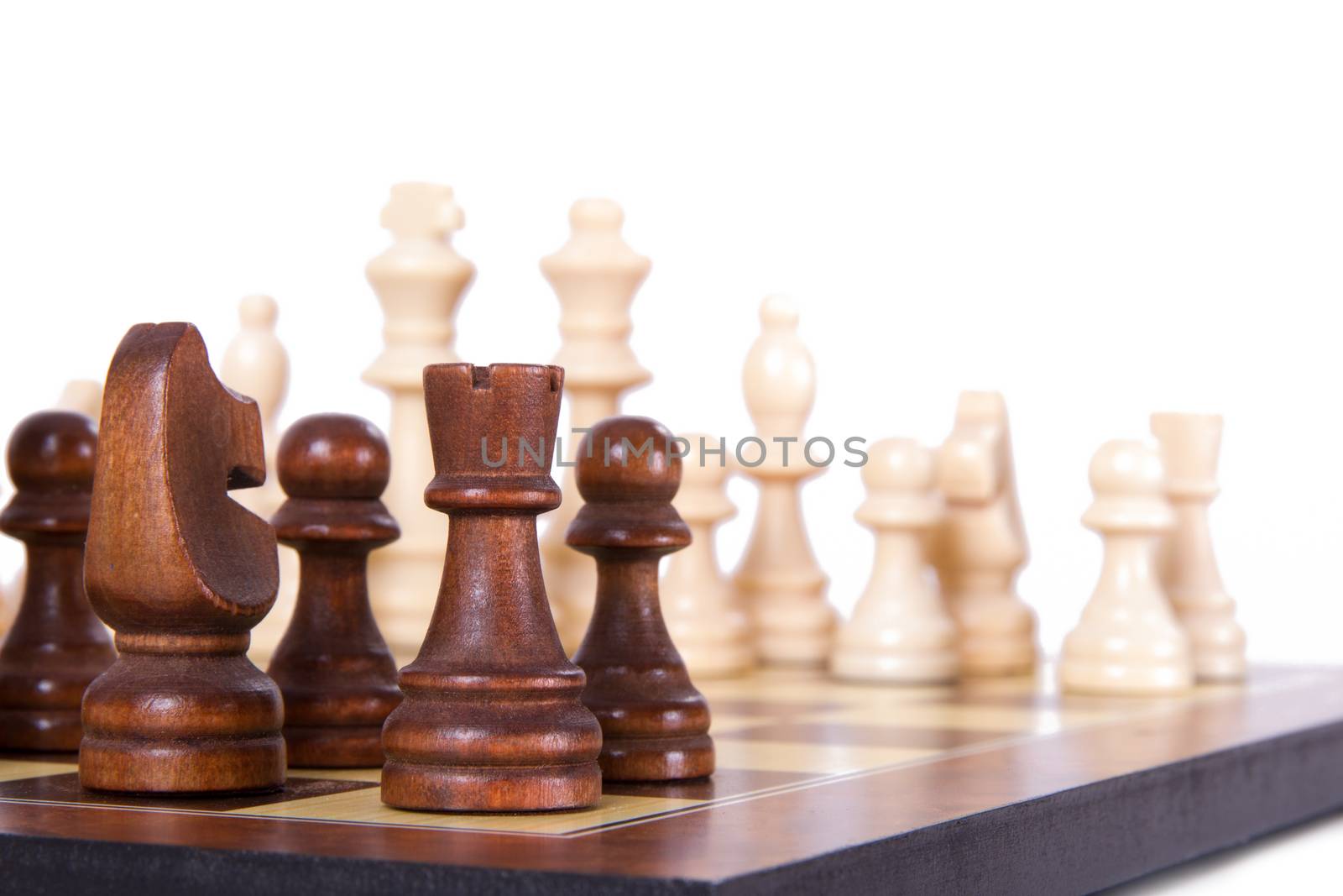 Chess board with starting positions aligned chess pieces, isolated on white background.