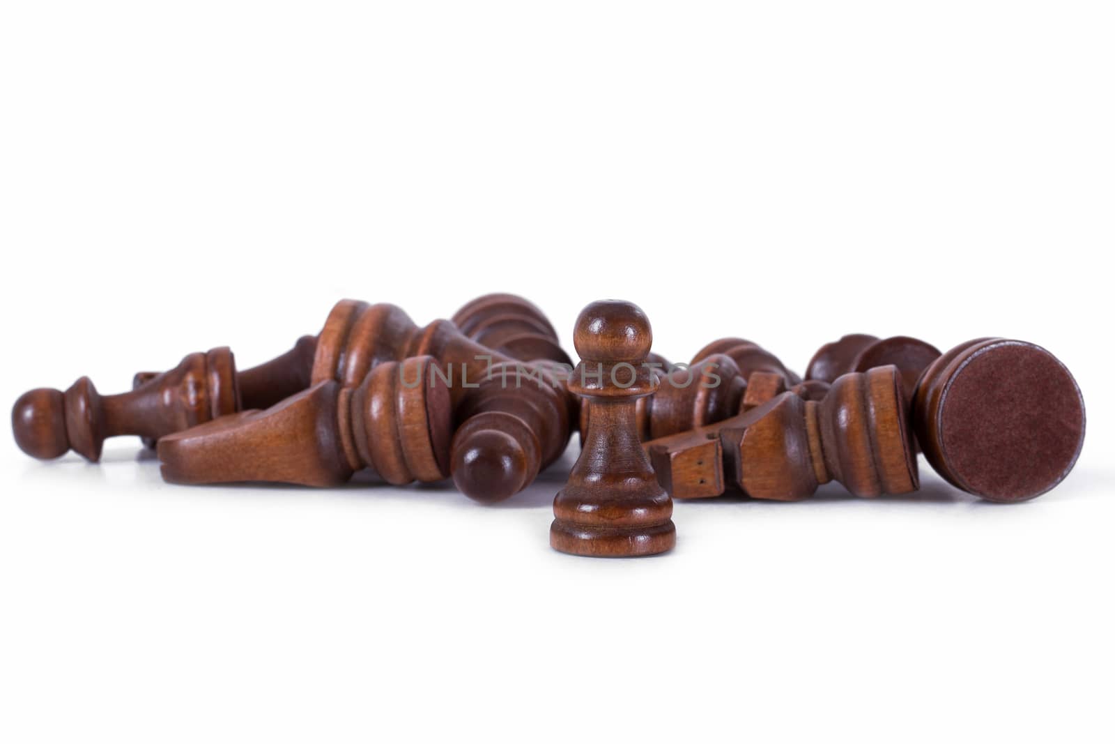 Single chess piece pawn standing against other pieces, isolated on white background.