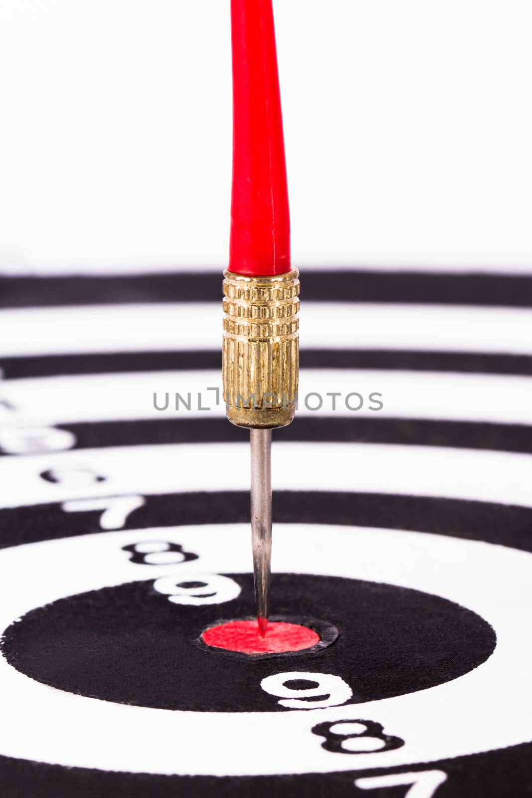 Arrow in the middle of dart board, isolated on white background.