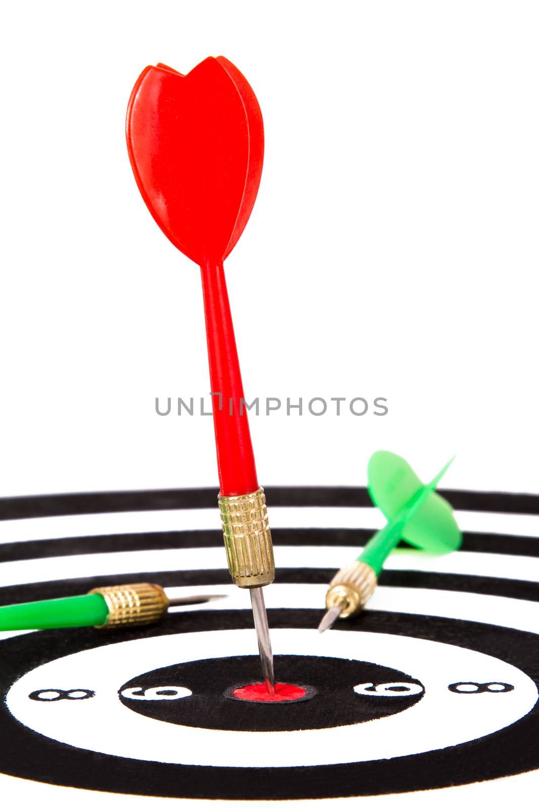 Red and green arrows on dart board, isolated on white background.