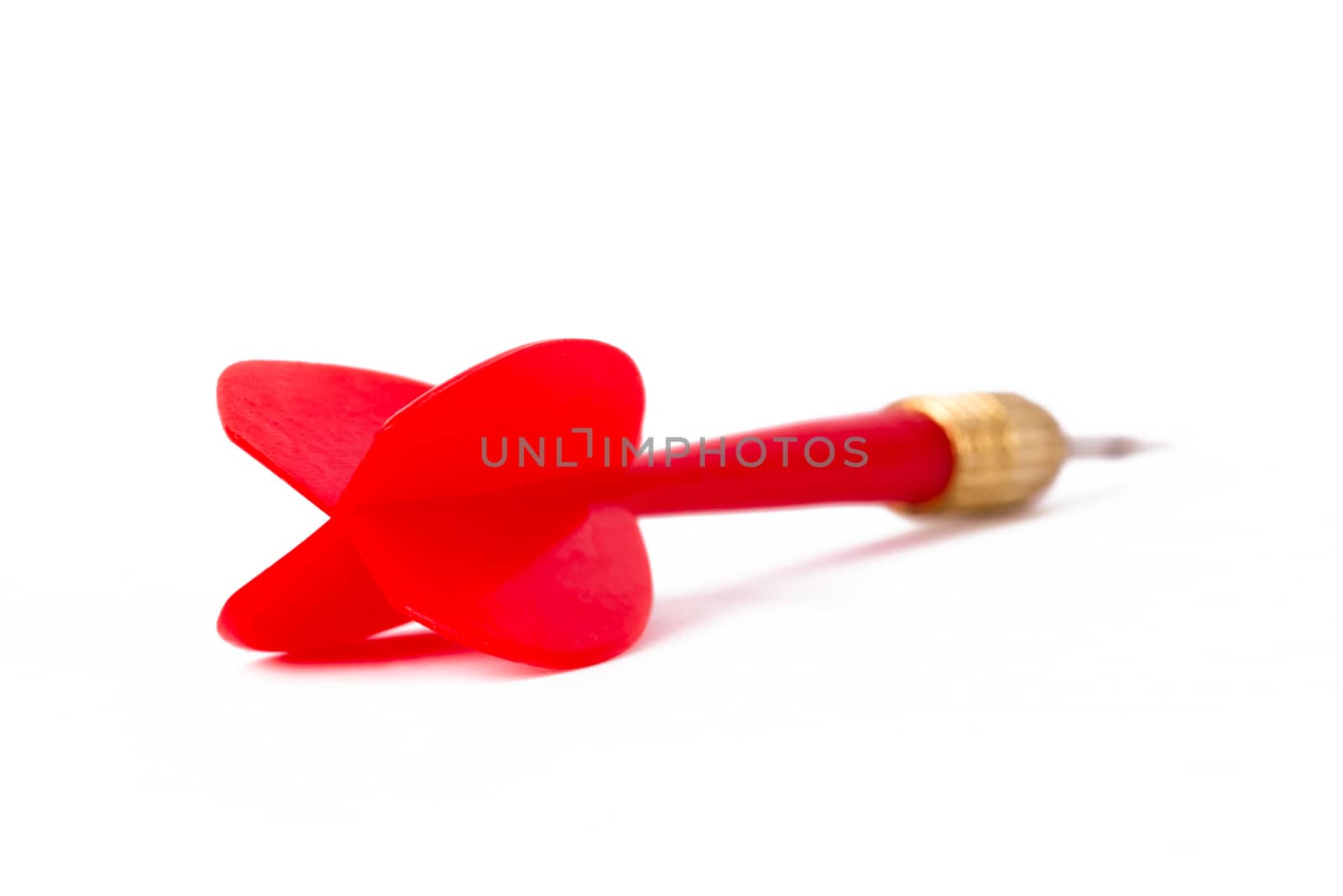 Single, red, plastic dart arrow, isolated on white background.