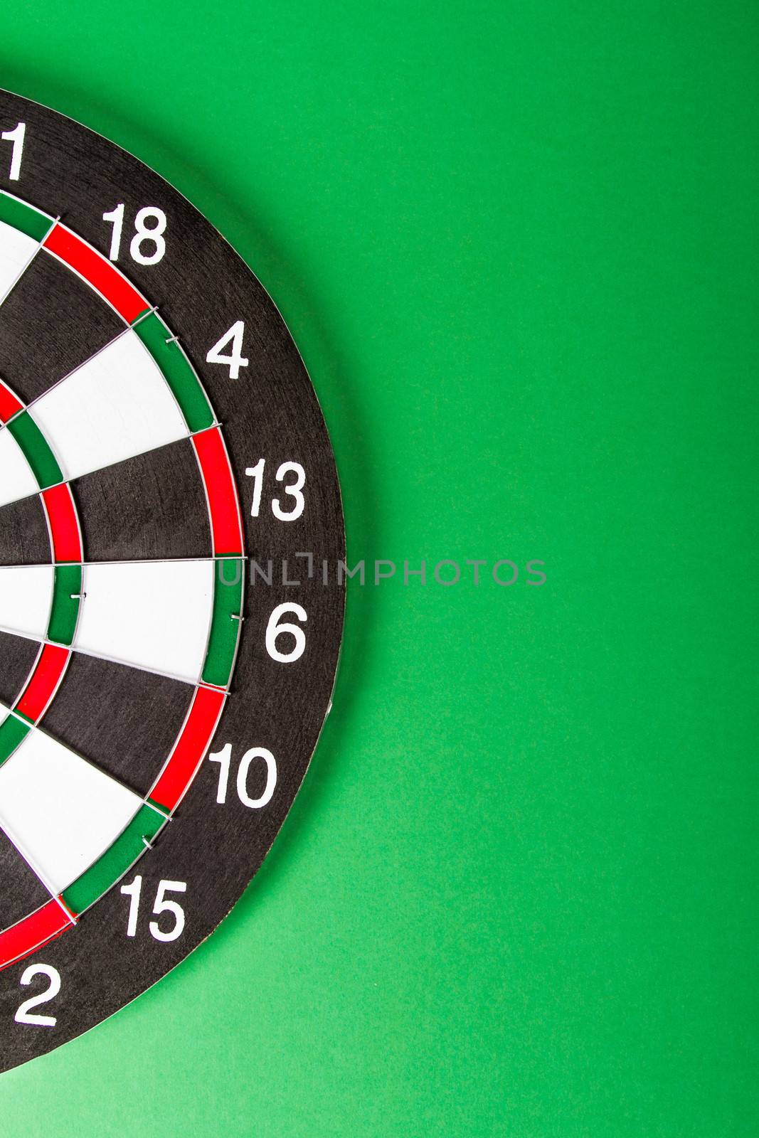 Dart board with black and white sections on green background.