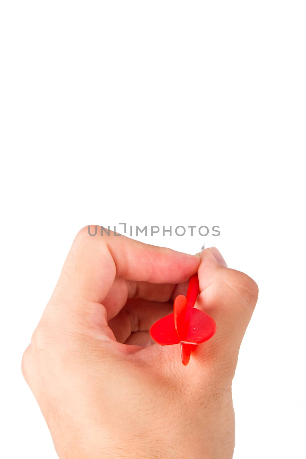 Hand holding red, plastic dart arrow, isolated on white background.