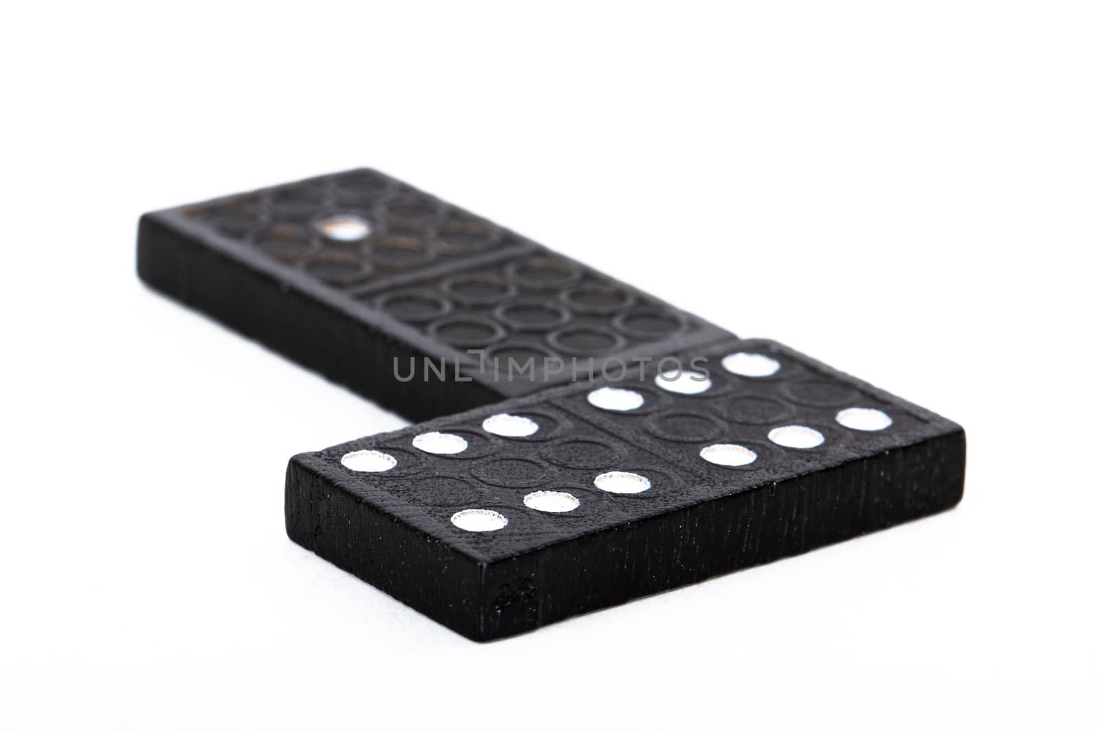 Black dominoes with depth of field, isolated on white background.