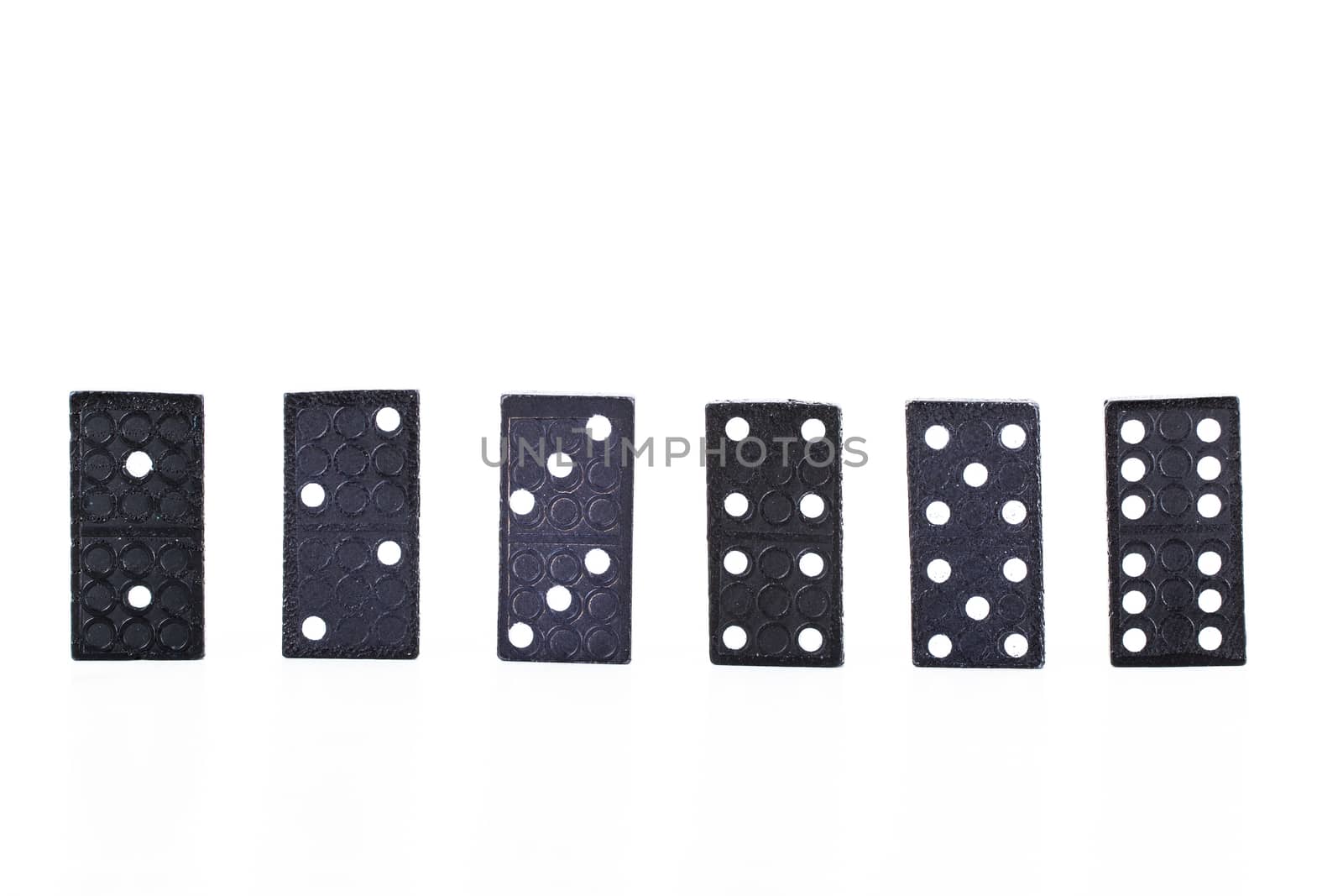 Set of dominoes pieces in a row, isolated on white background.