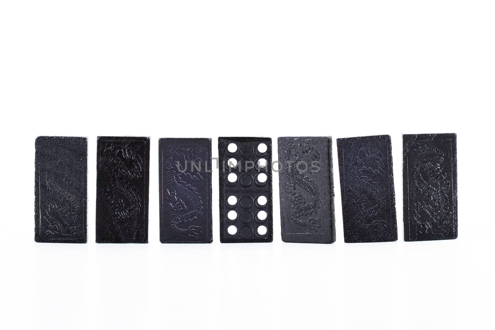 Black dominoes in a row, isolated on white background.