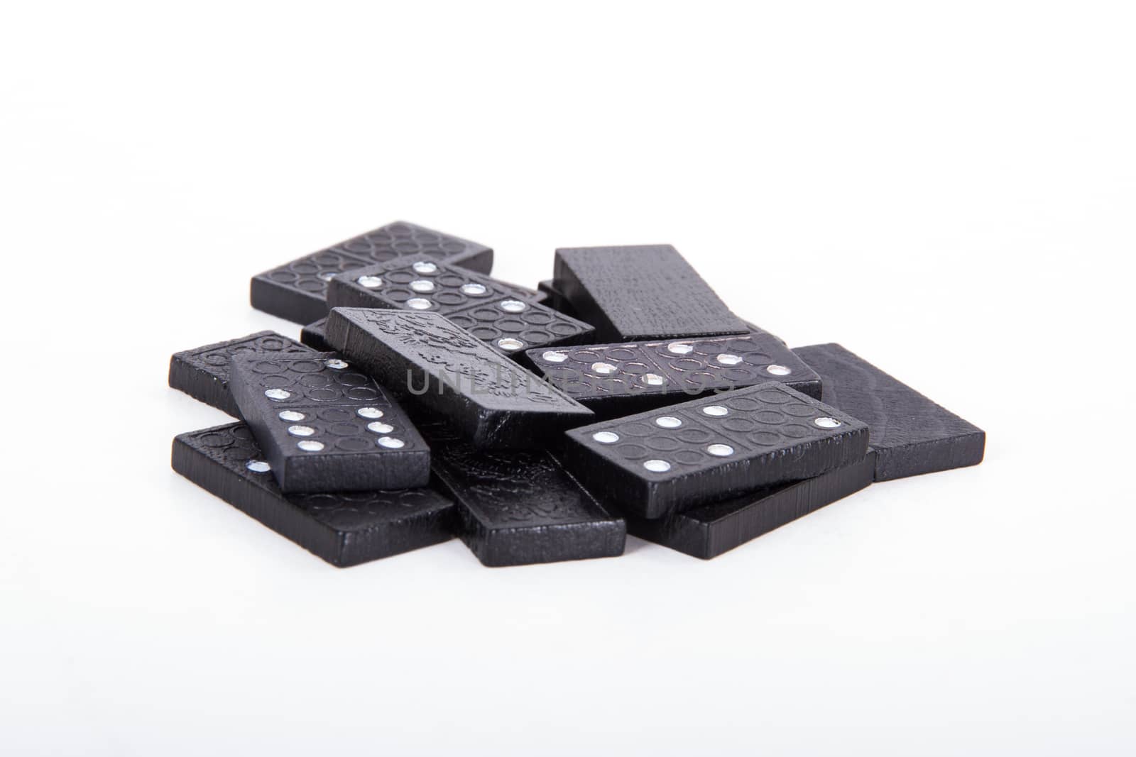 Stack of black dominoes, isolated on white background.