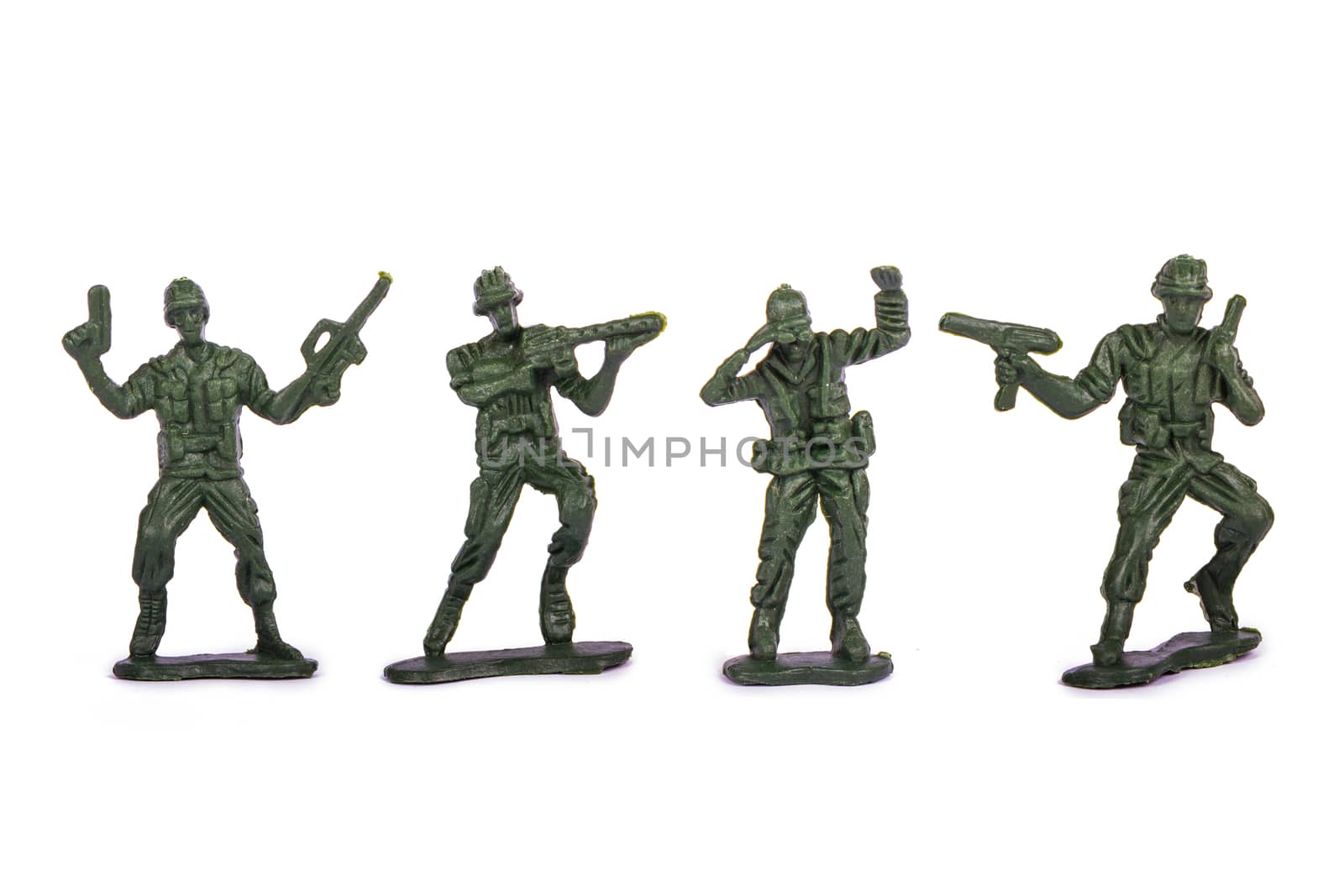 Group of miniature toy soldiers, isolated on white background.
