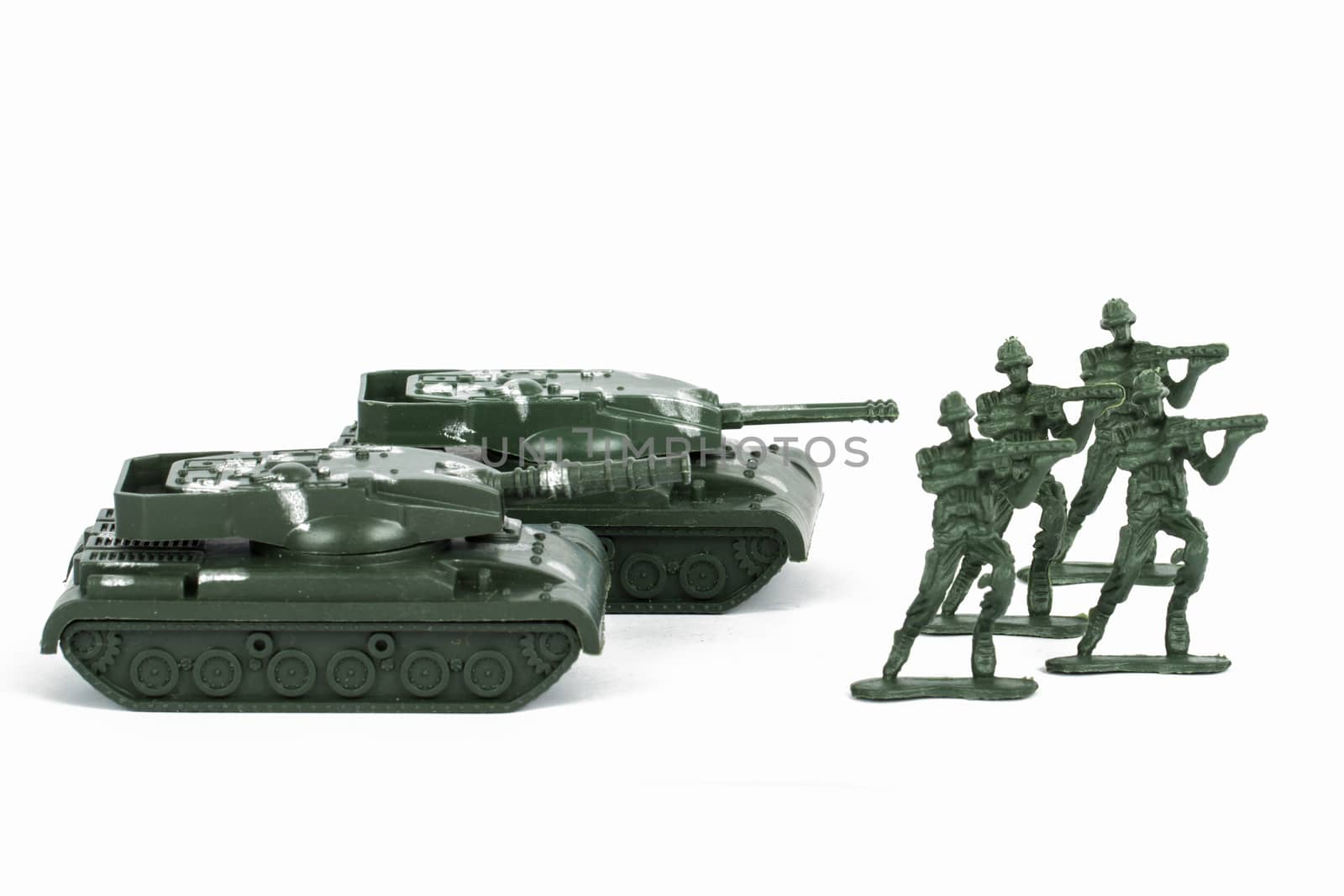 Miniature toy tank and attacker soldiers, isolated on white background.