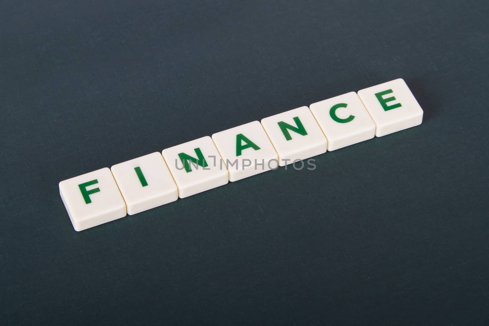 Finance word in letters on background.
