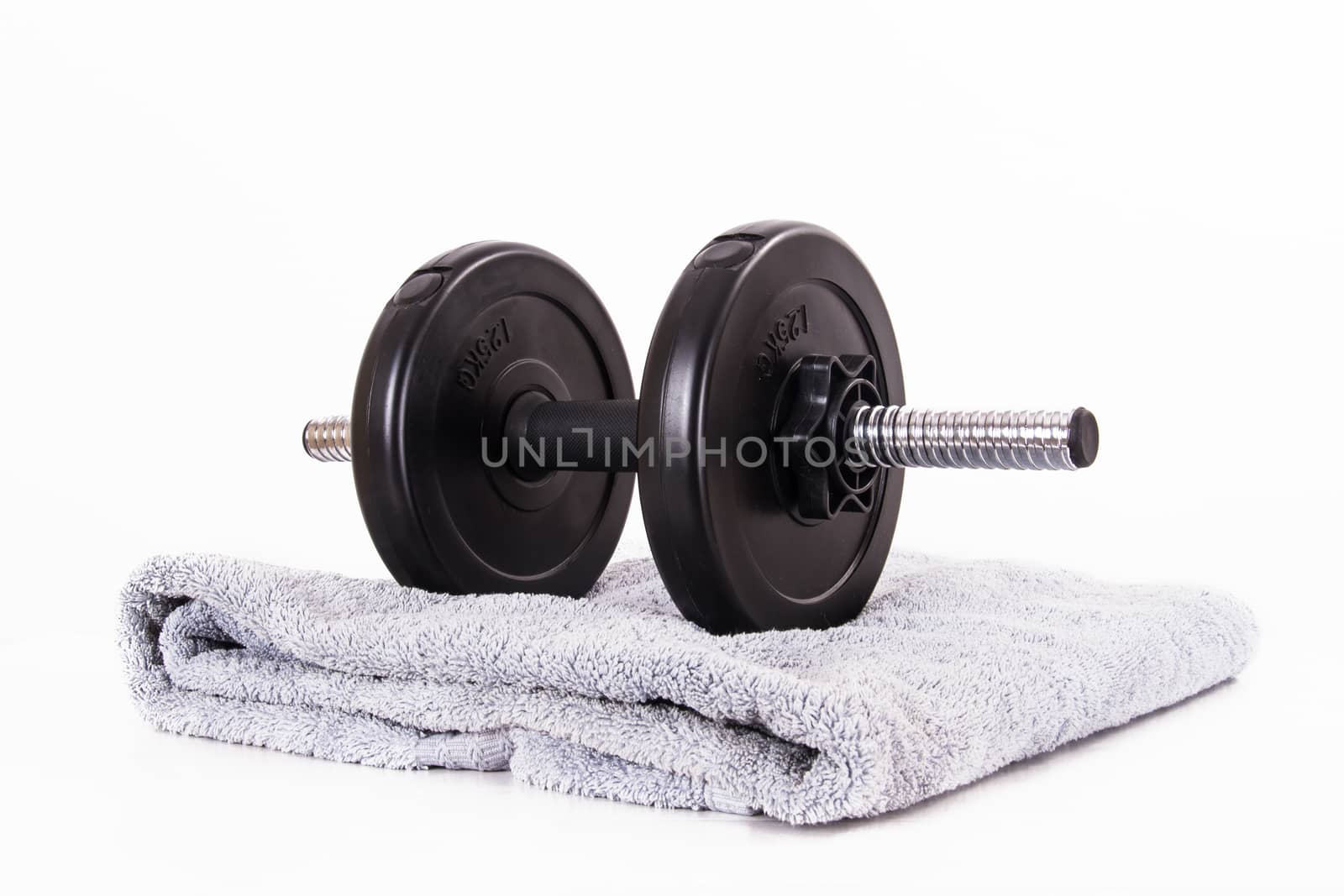 Black gym barbell, dumbbell with disks and blue towel, isolated on white background.