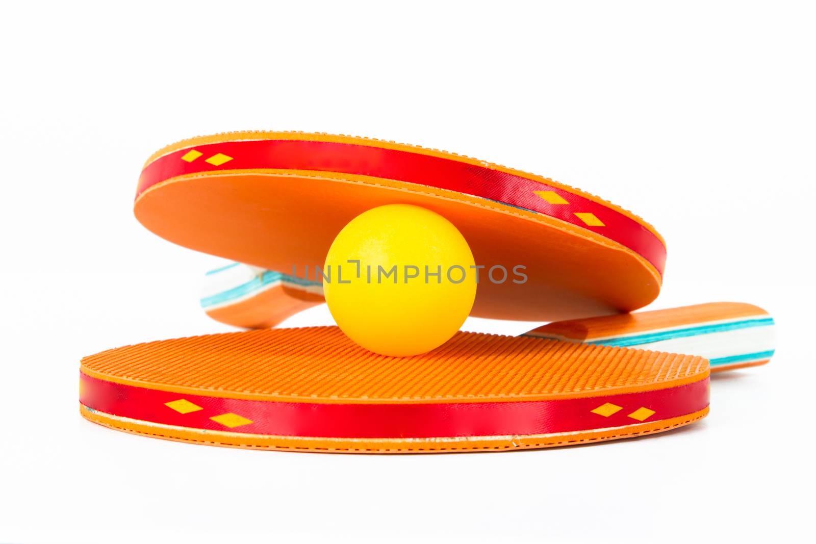 Orange ping pong rackets and ball, isolated on white background.
