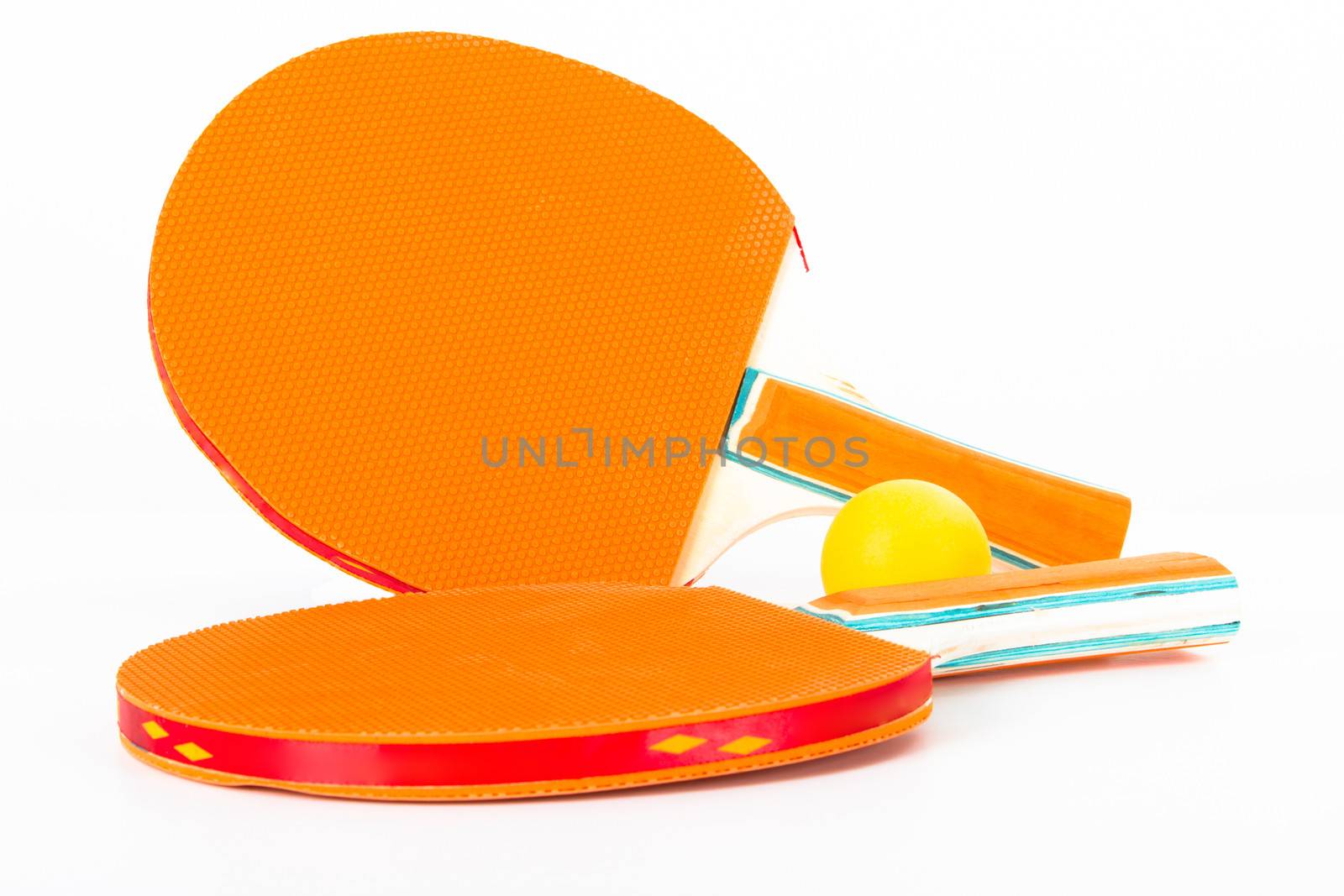 Table tennis rackets and ball, isolated on white background.