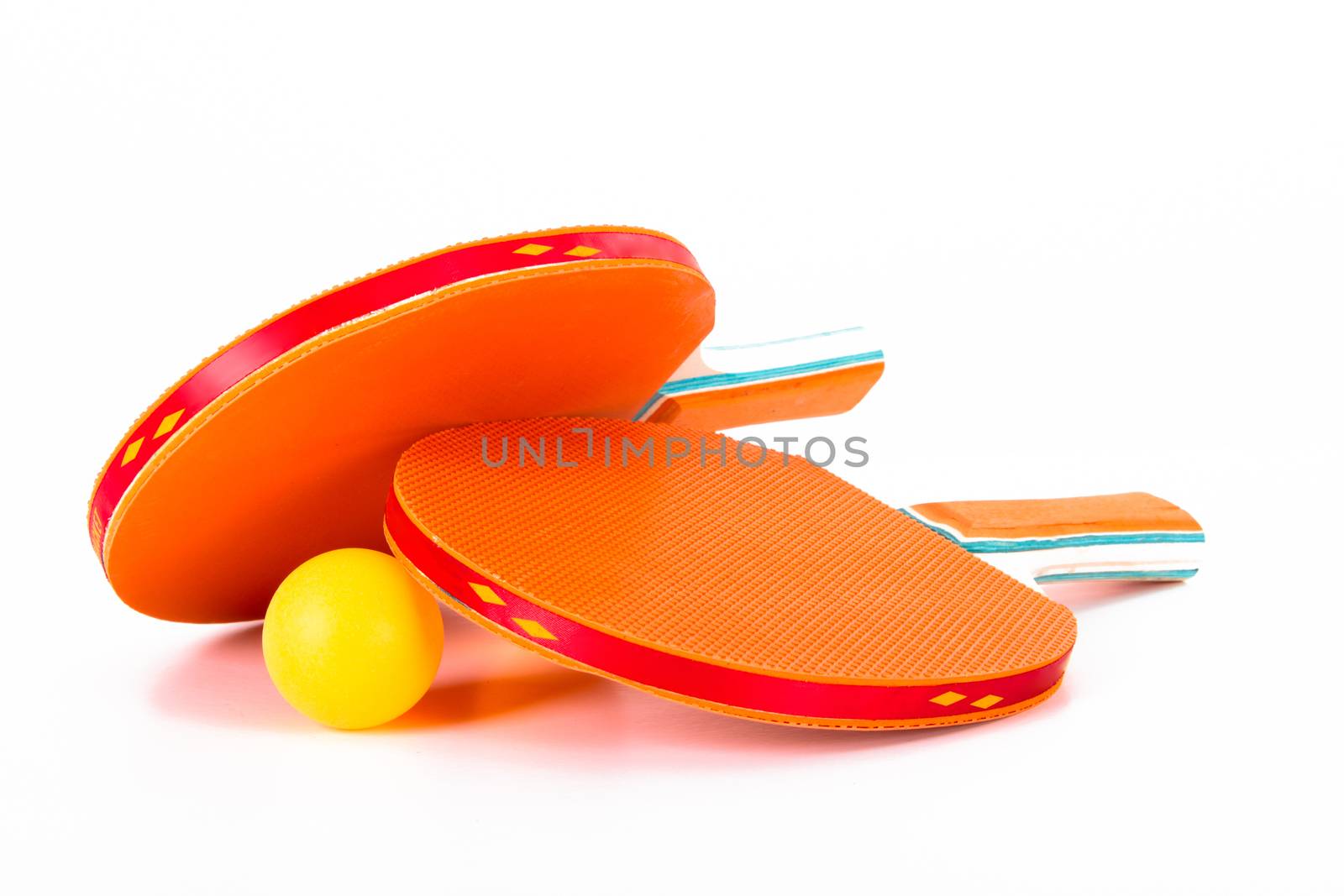 Orange ping pong rackets and ball, isolated on white background.