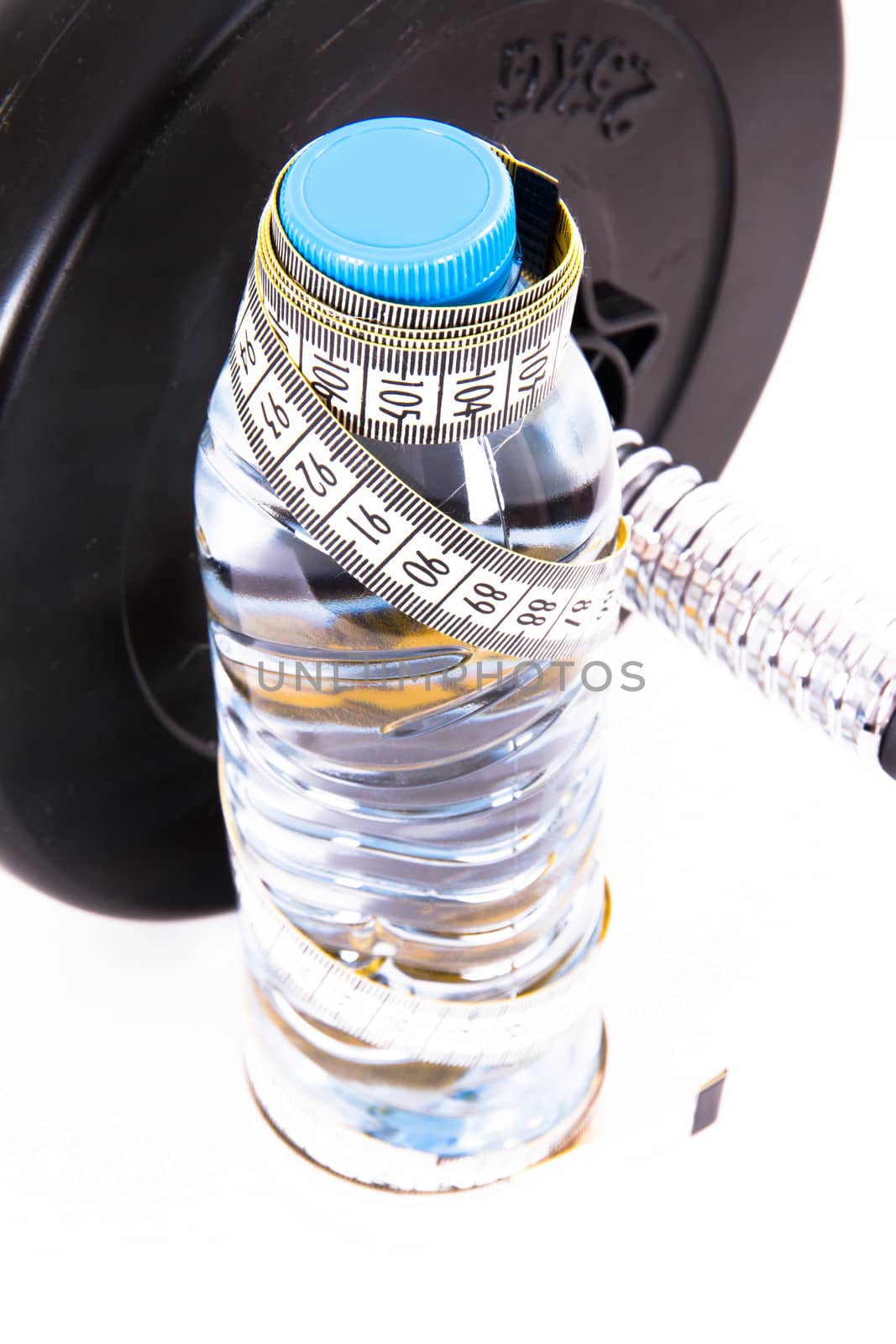 Plastic water bottle with tape measure and dumbbell, barbell, isolated on white background.