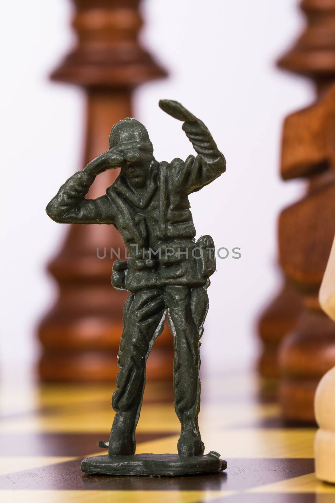 Close up view of miniature toy soldier on chess board.